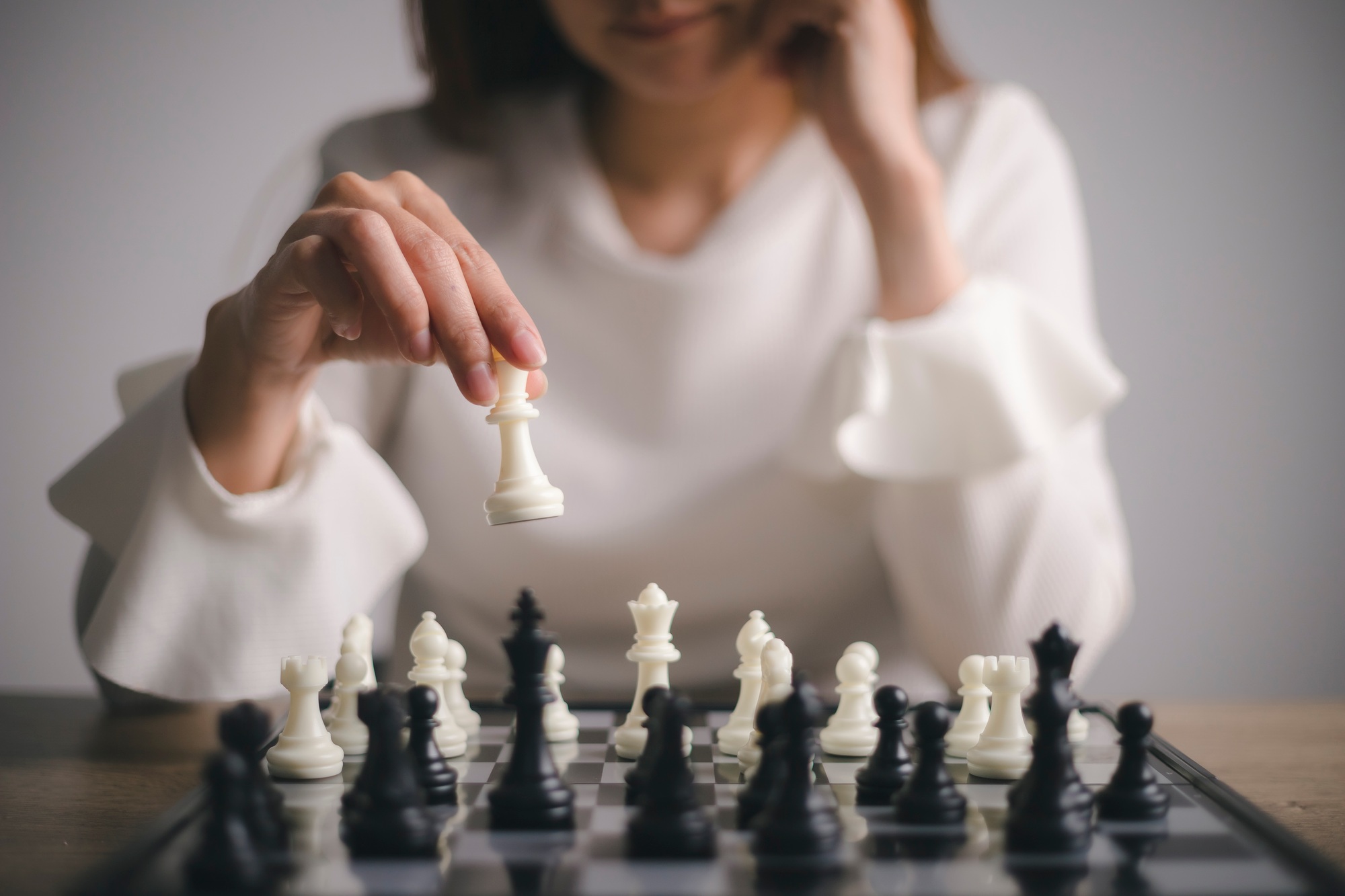 Businesswoman plays with chess game. concept of business strategy and tactic. strategy, management,