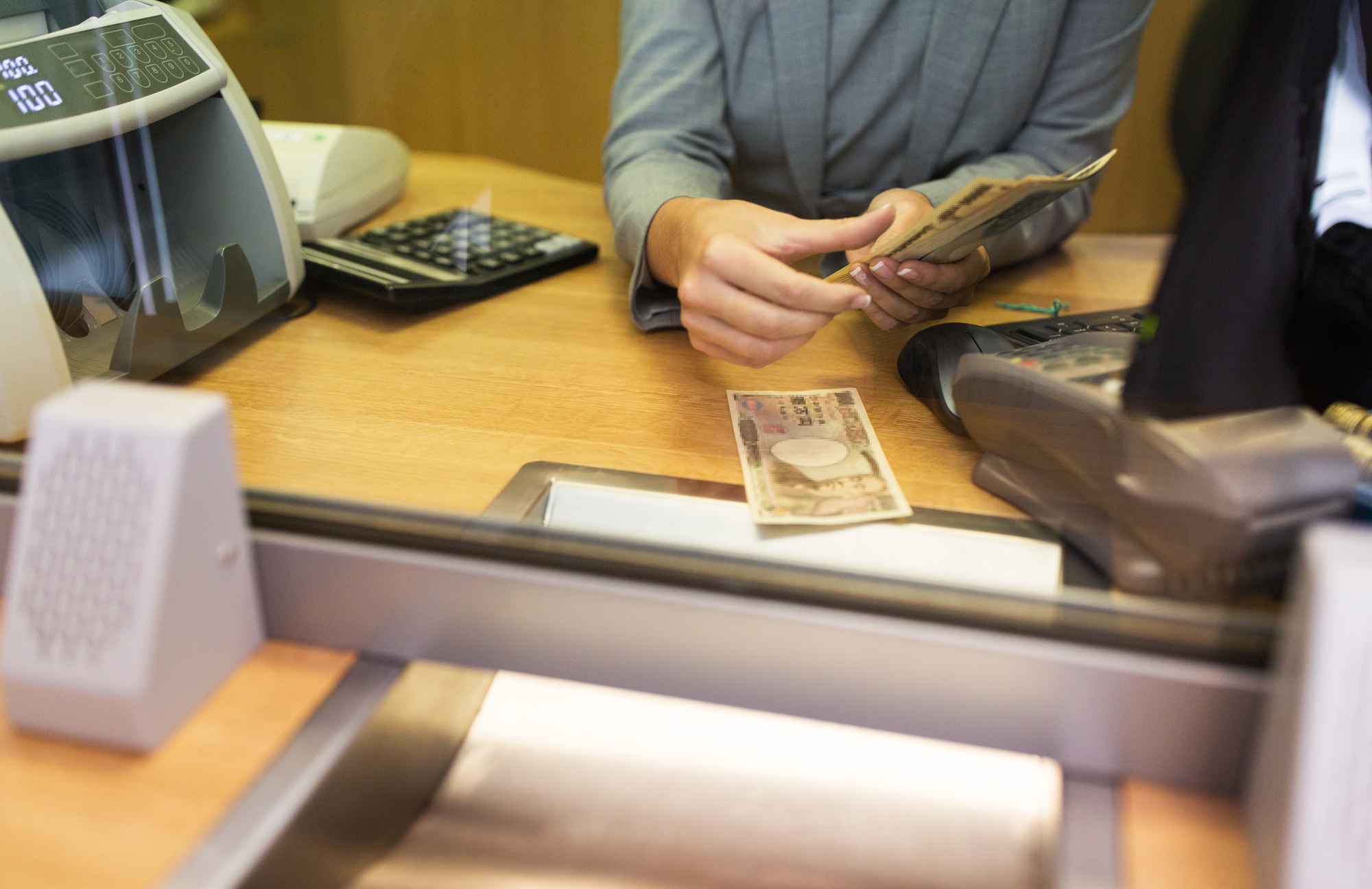 clerk counting cash money at bank office