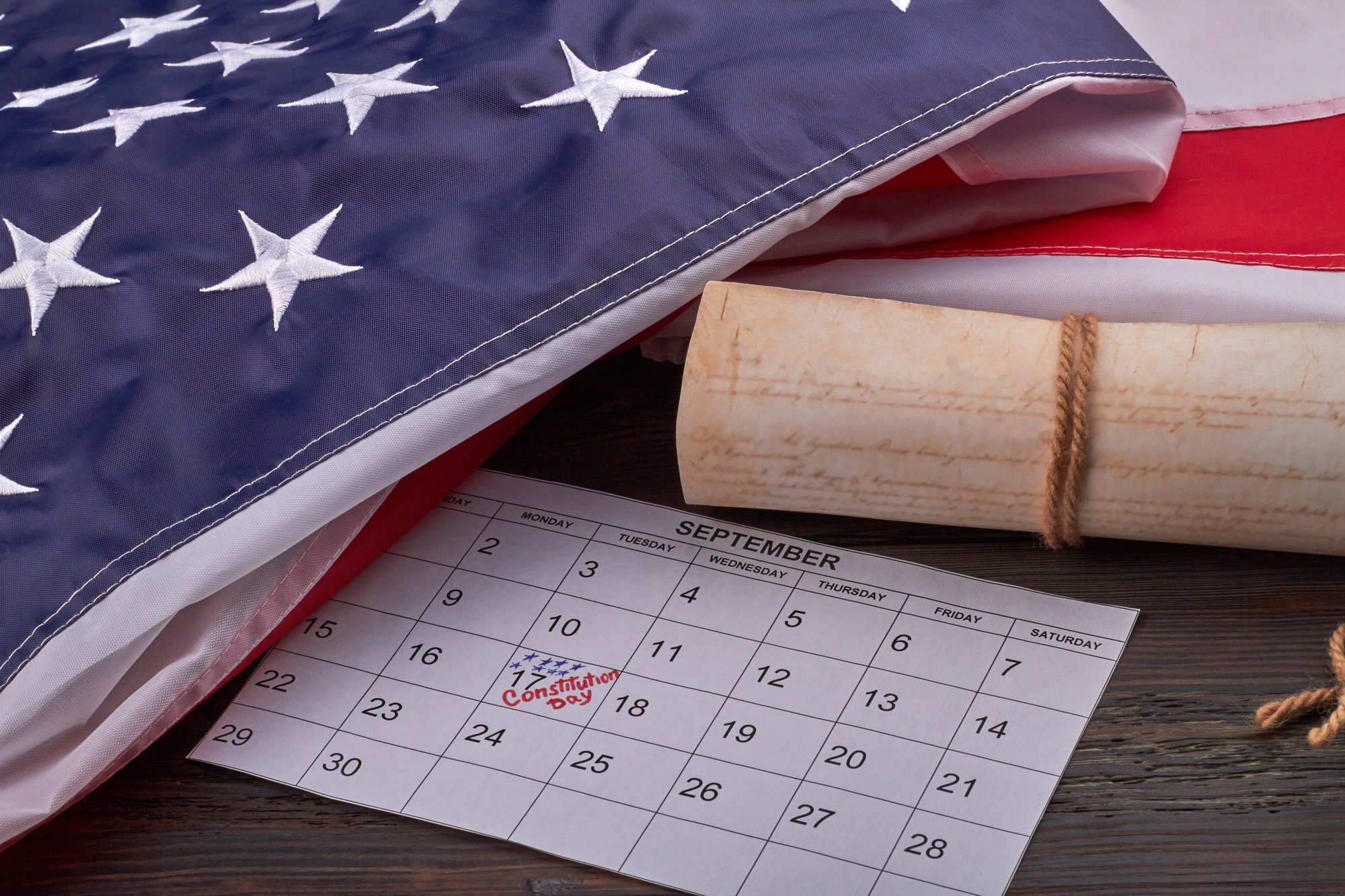 Close-up calendar with september 17th with scroll and US flag.