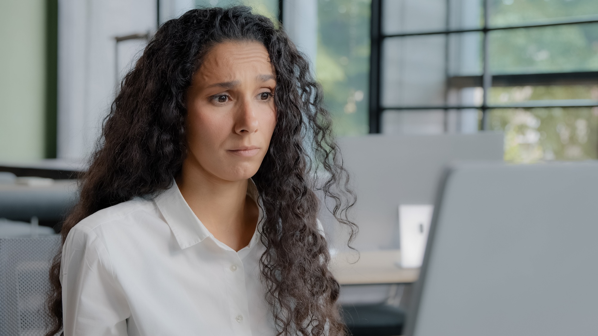 Close-up upset excited young woman looking at computer screen reading bad news receives nasty