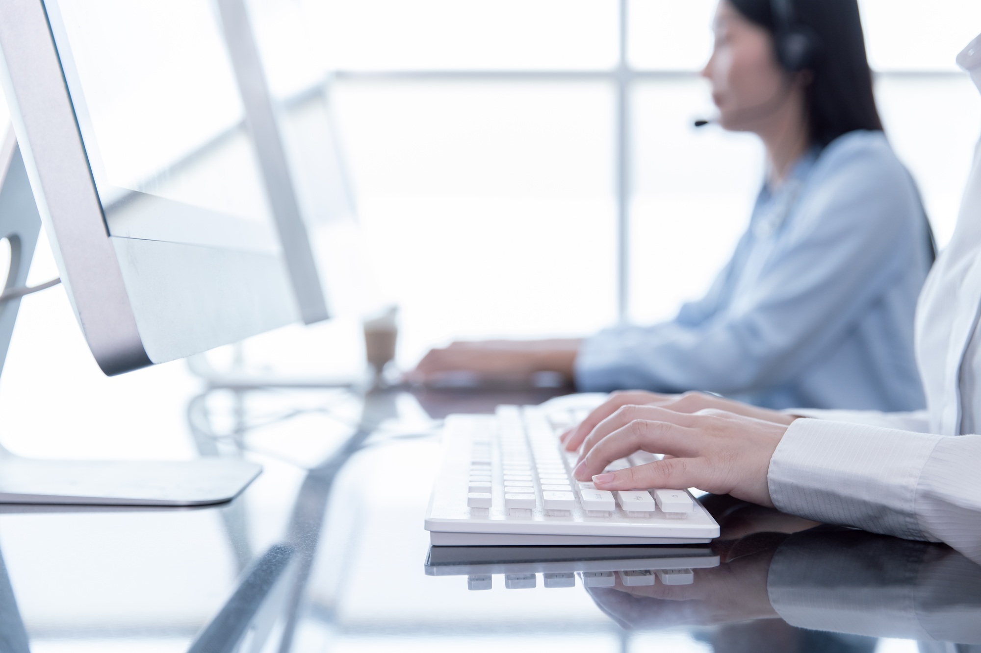 Closeup hand officer typing record customer data in computer CRM software. People call center work