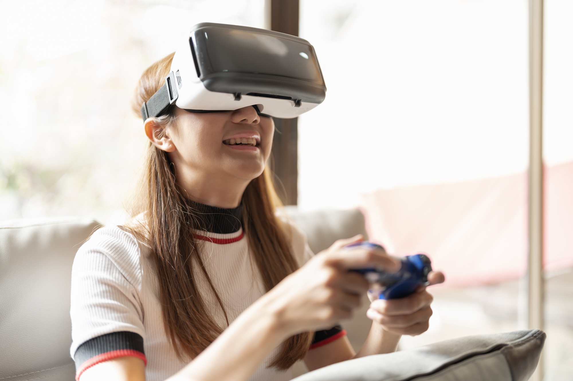 Concept of technology,gaming,entertainment and people.asian woman enjoying virtual reality glasses