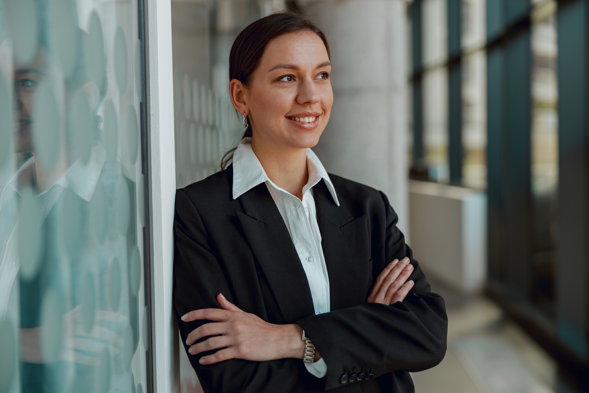 Confident businesswoman standing in modern office, exuding professionalism and leadership
