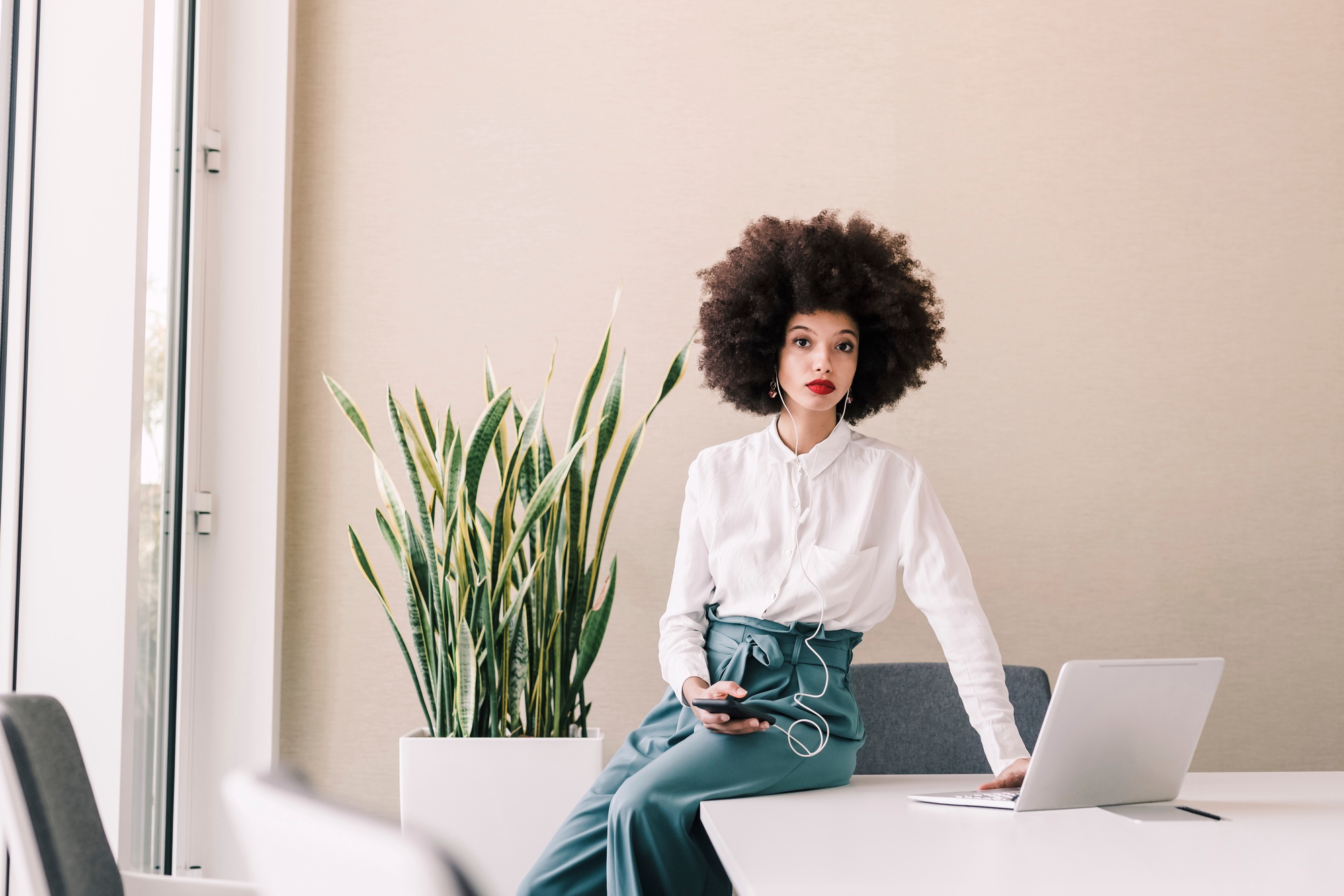 Confident professional working at a minimalist office setup.