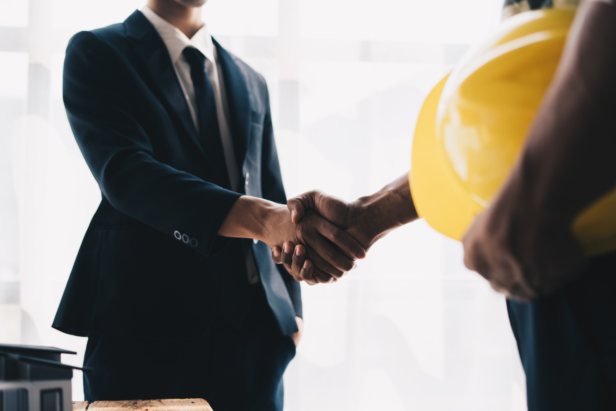 Construction worker team hands shaking greeting start up plan new project contract in office