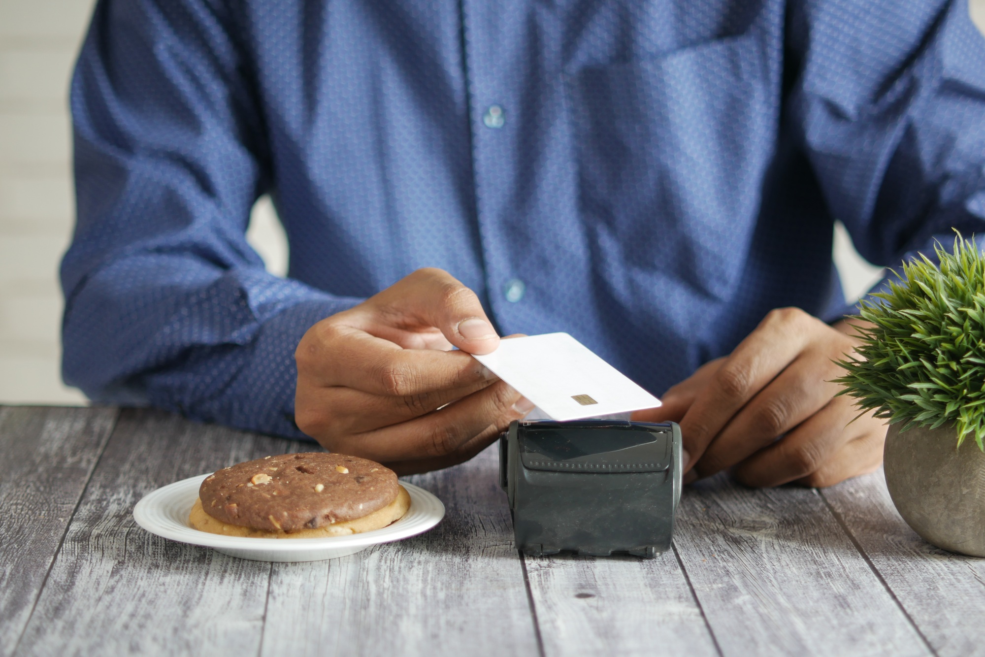contactless payment concept with young man paying with credit card