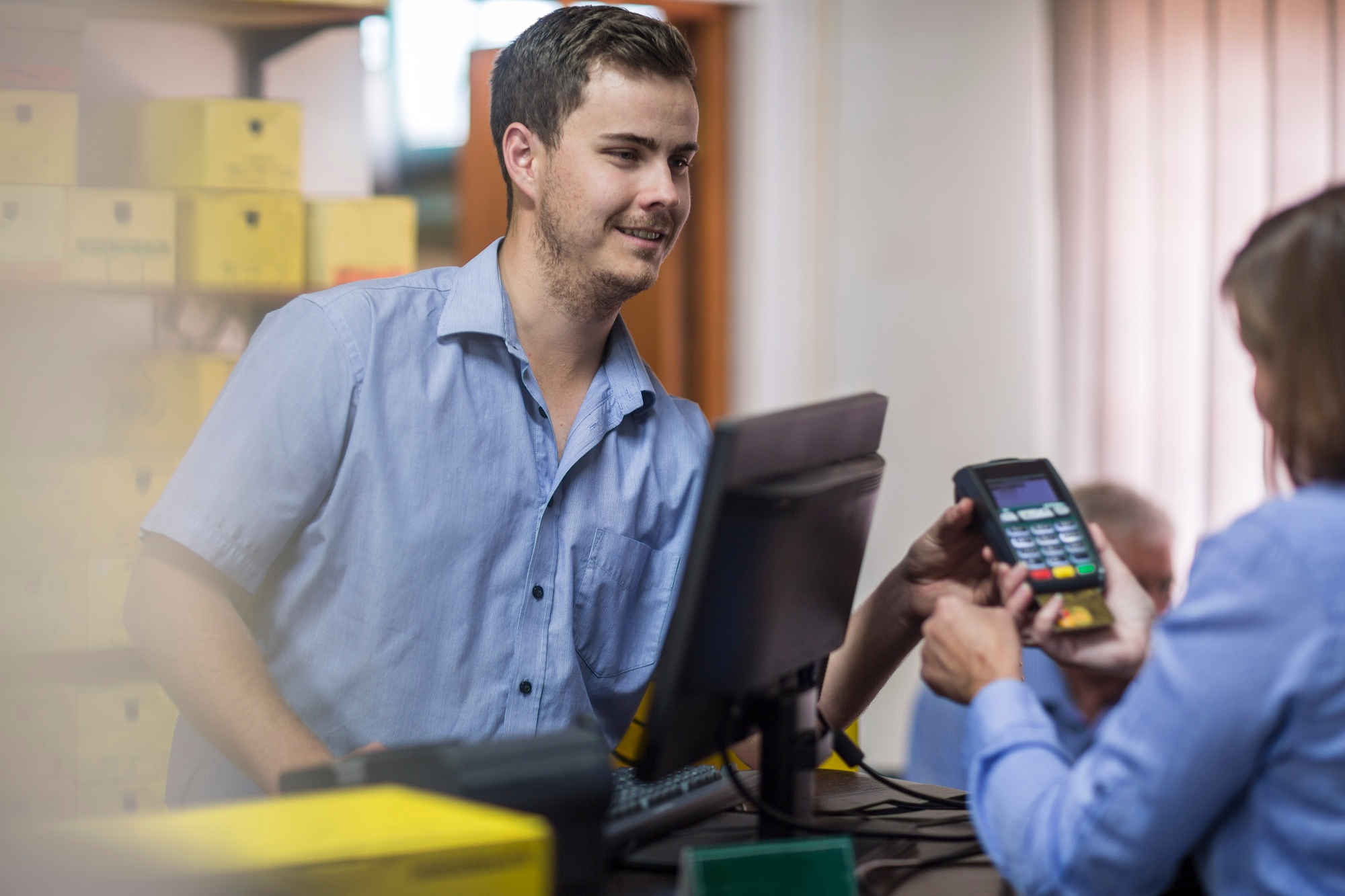 Customer using credit card reader at store