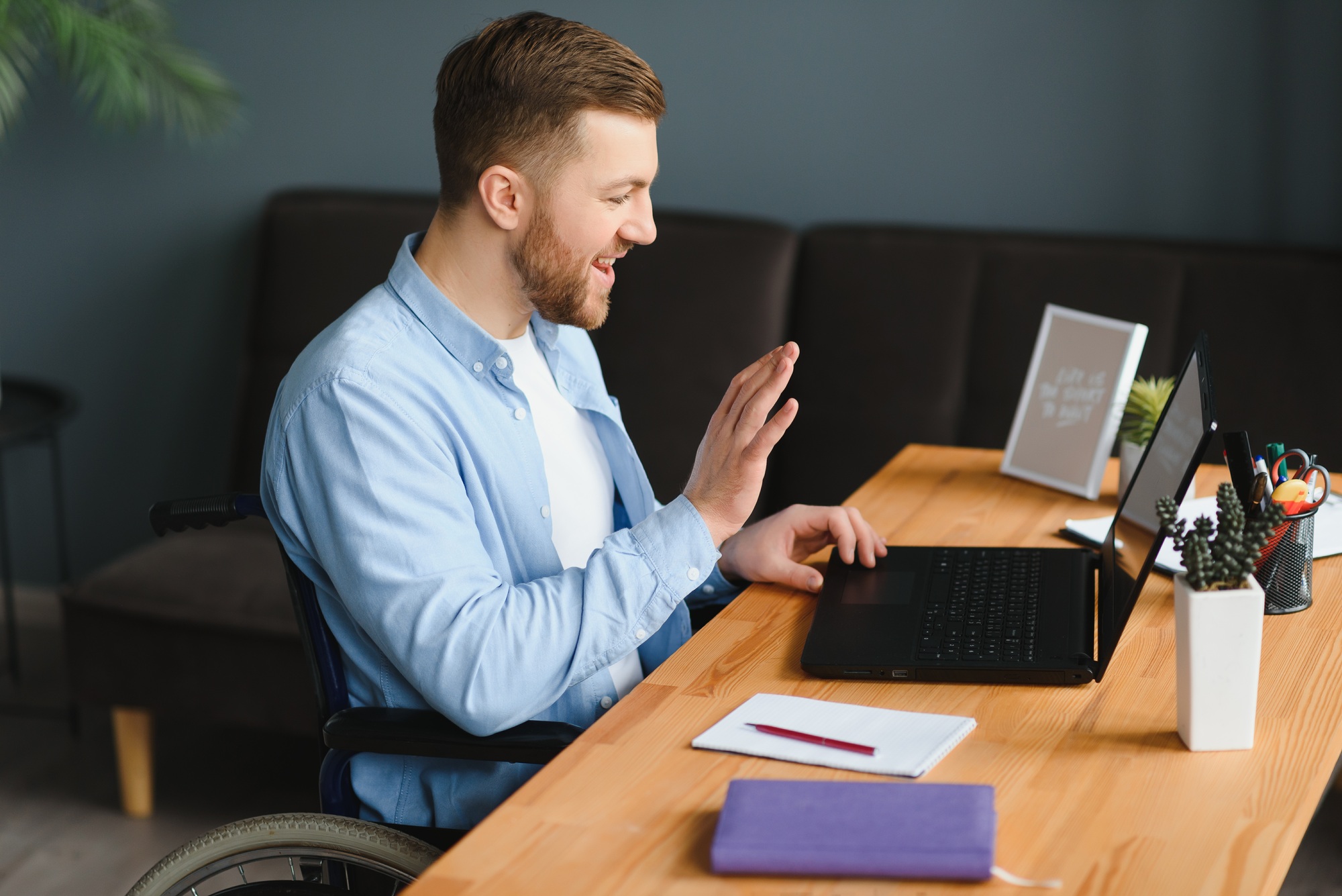 Disabled Virtual Assistant In Wheelchair Making Remote Video Call.