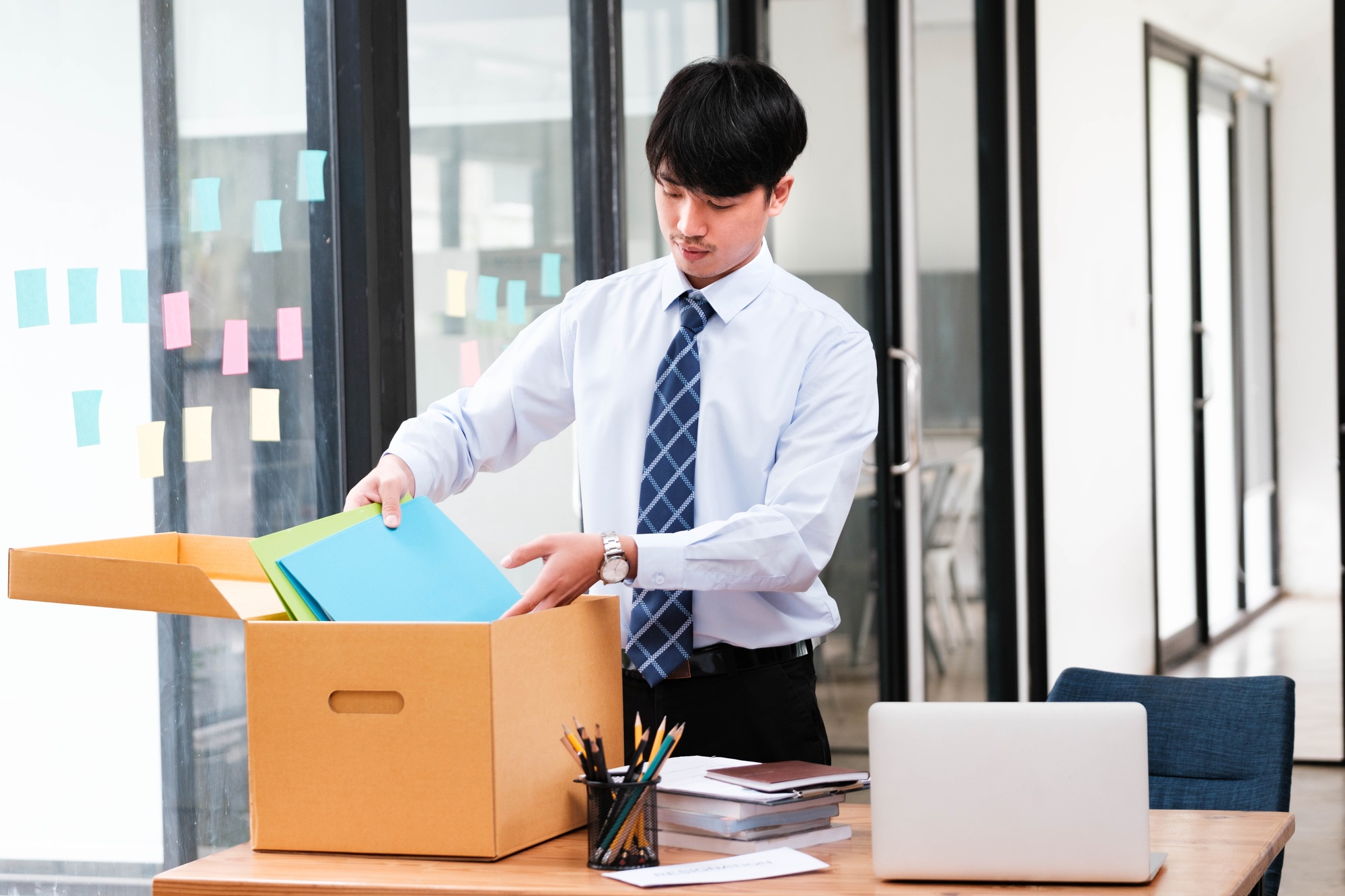 Employee packing belongings into a box during a job change or resignation