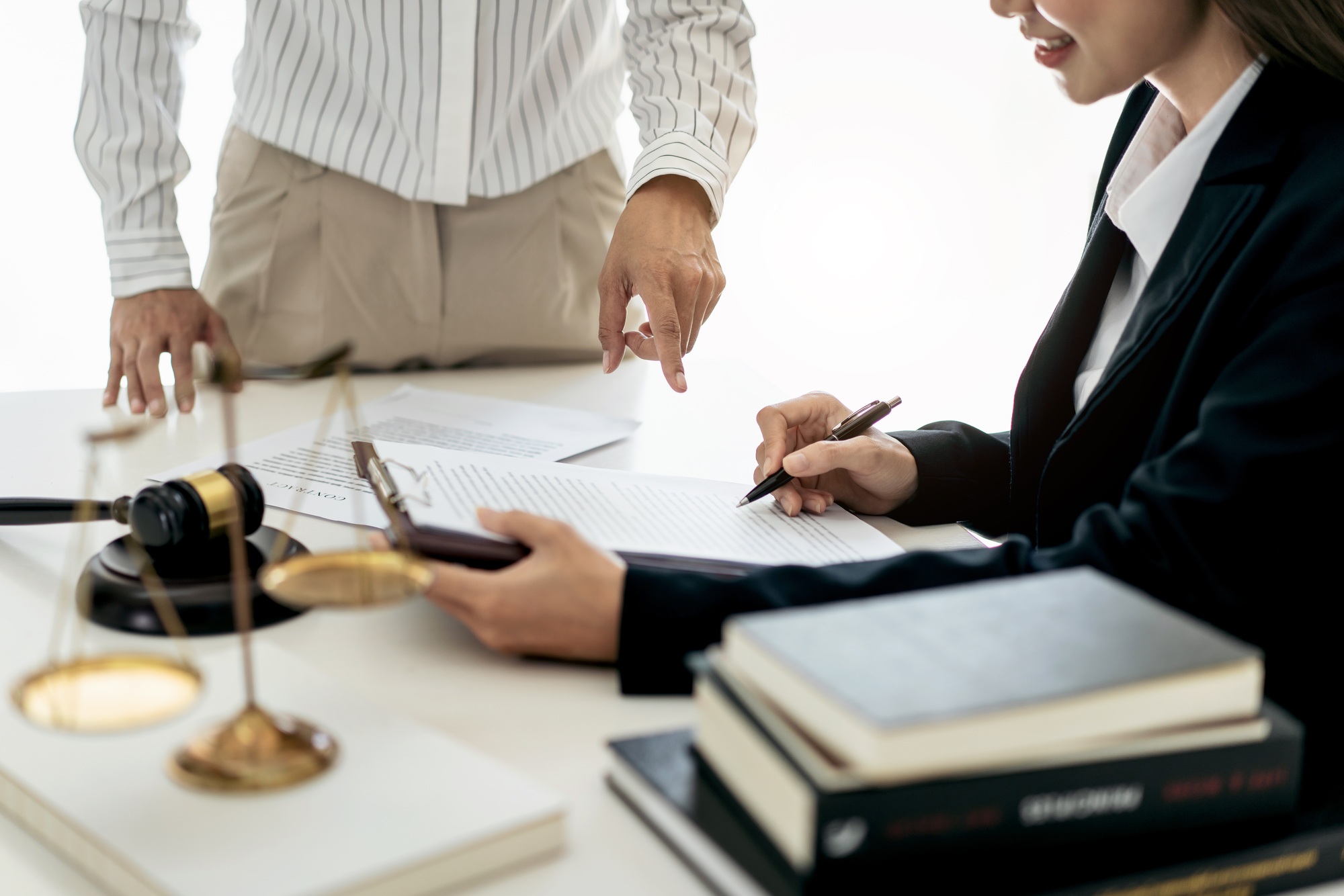 Female lawyer is reading business contract and giving advice about laws and agreements of contract