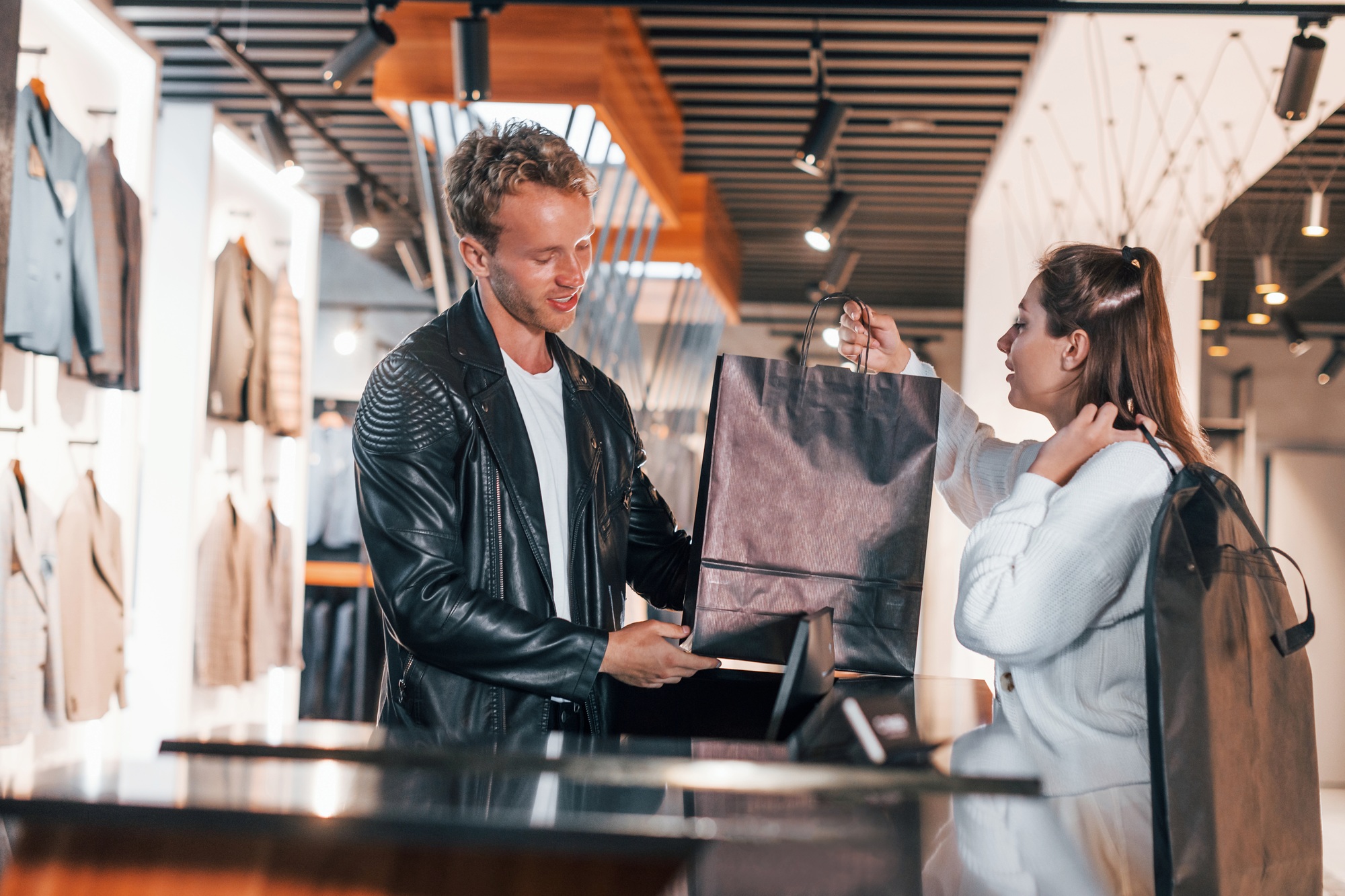 Female worker serves the guy at the checkout