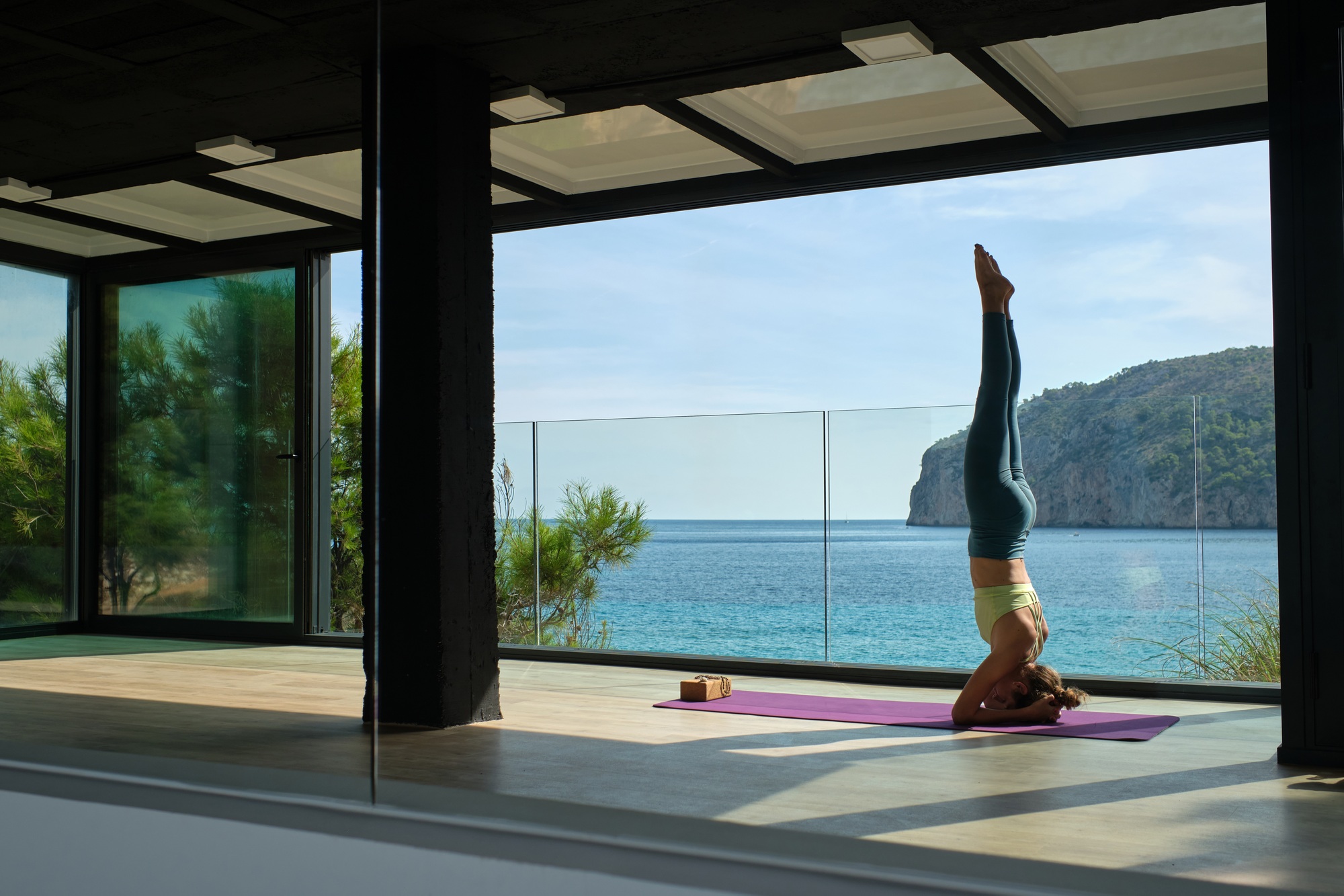 Fit woman doing Supported Headstand for stress relief