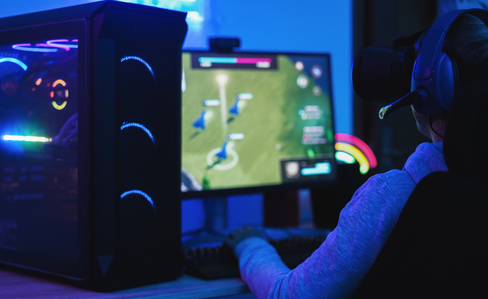 Girl gamer playing at strategy game online using virtual reality head set