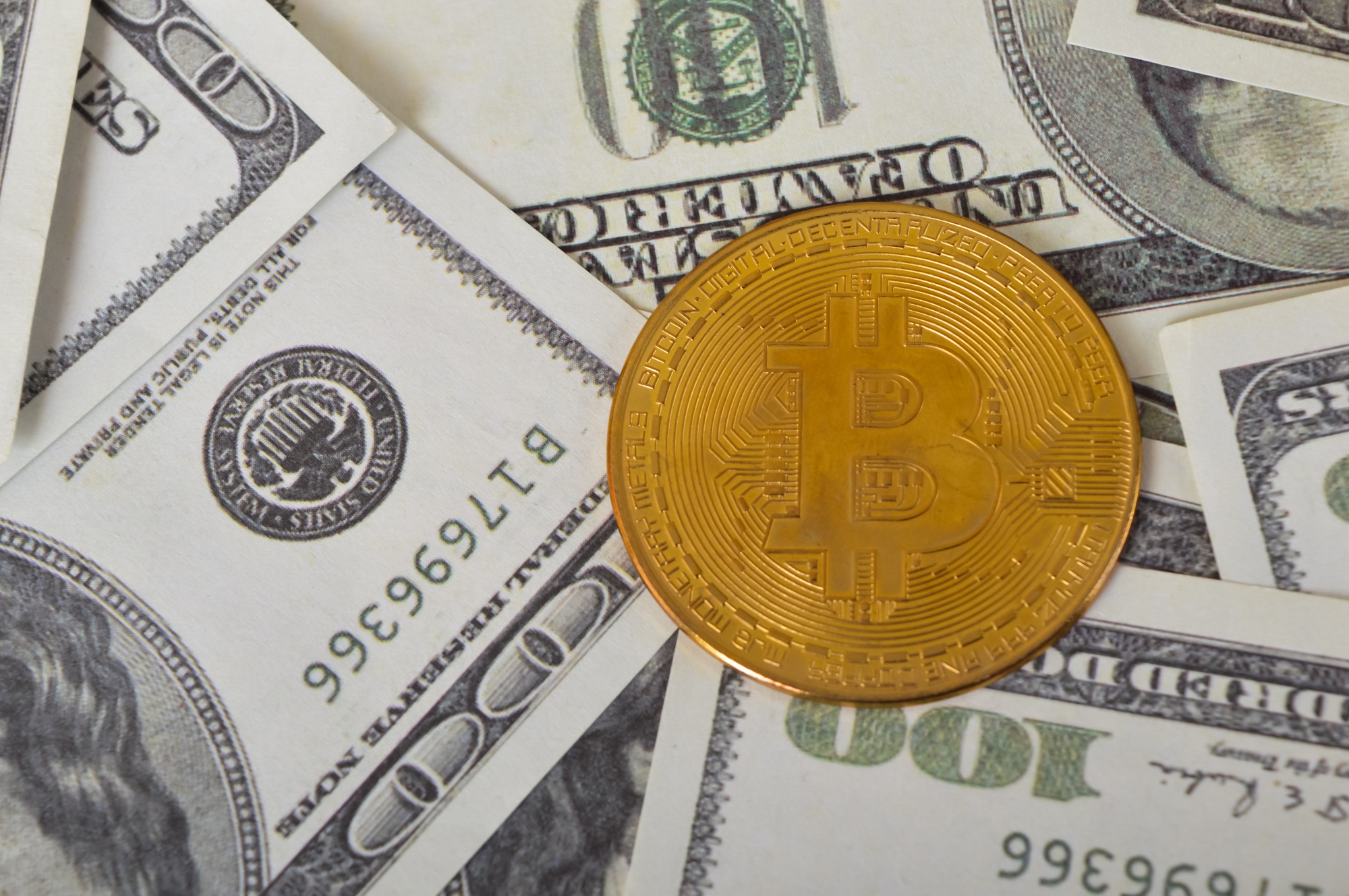 Golden bitcoin and heap of dollars. Financial and bitcoin cryptocurrency. concept.