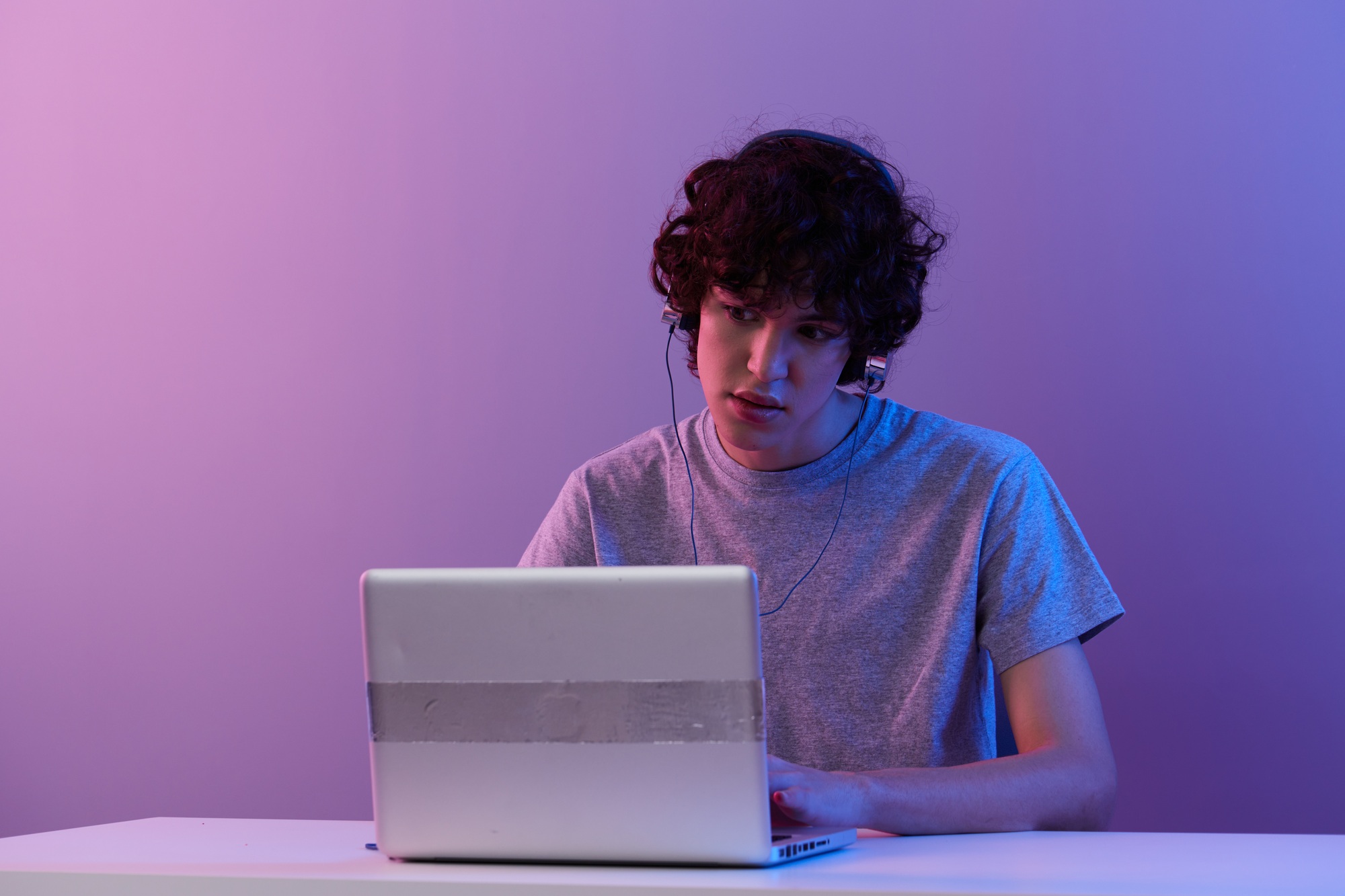 guy in headphones in front of laptop entertainment Lifestyle technology