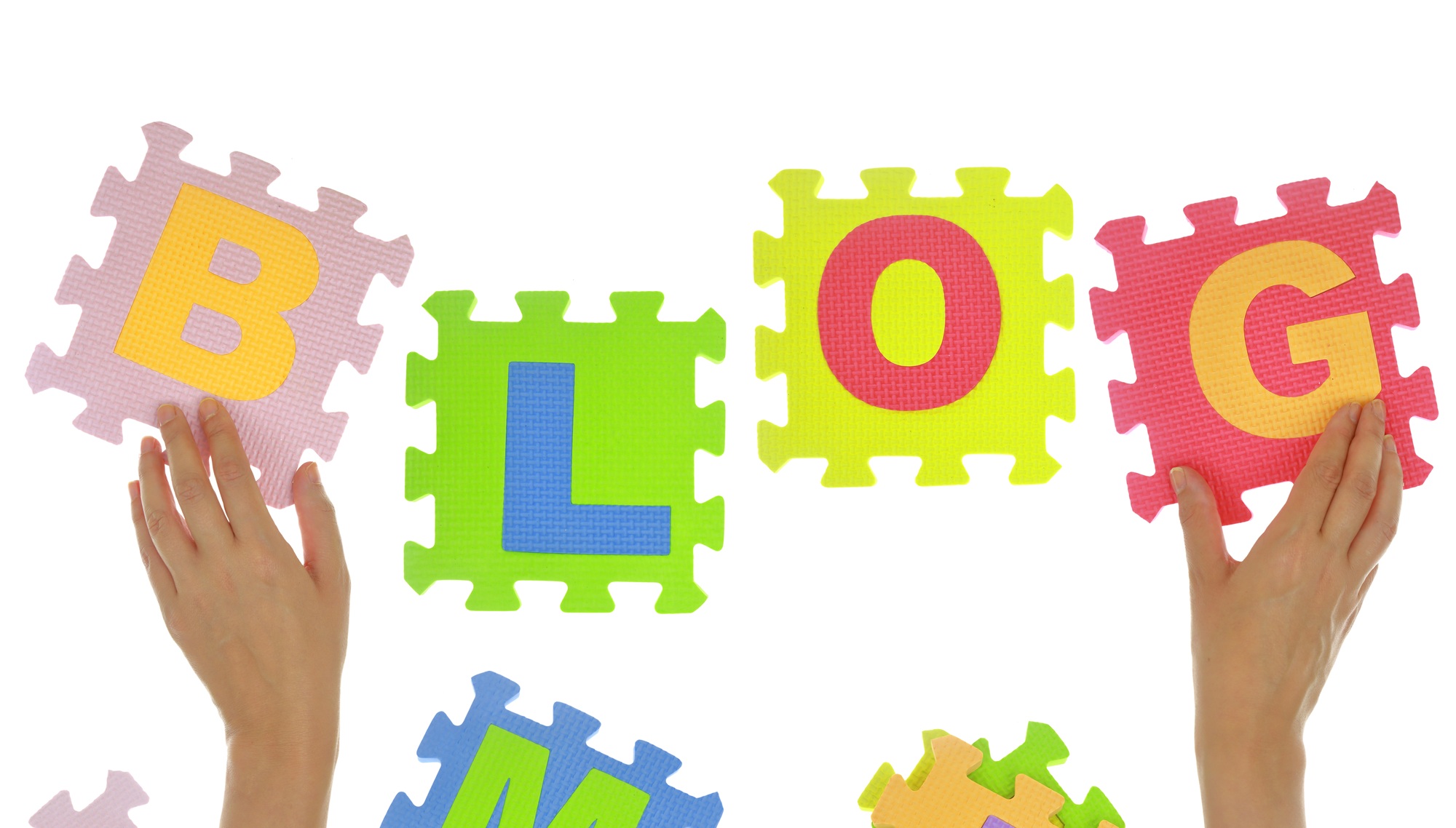 Hands forming word "Blog" with jigsaw puzzle pieces isolated