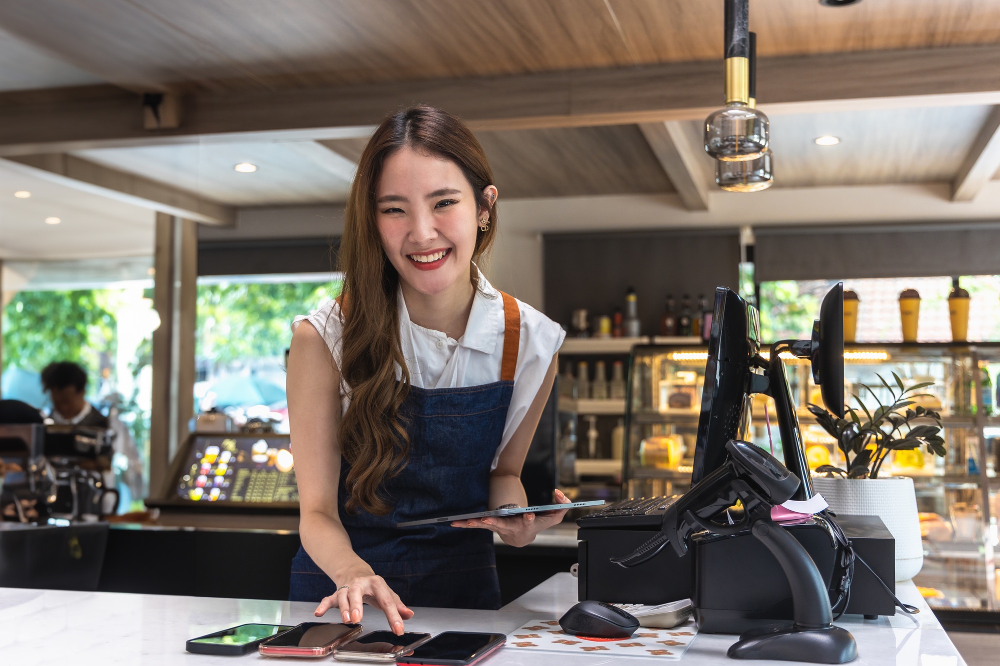 Happy Asian Young Woman Checking Customer Orders on Mobile Phone