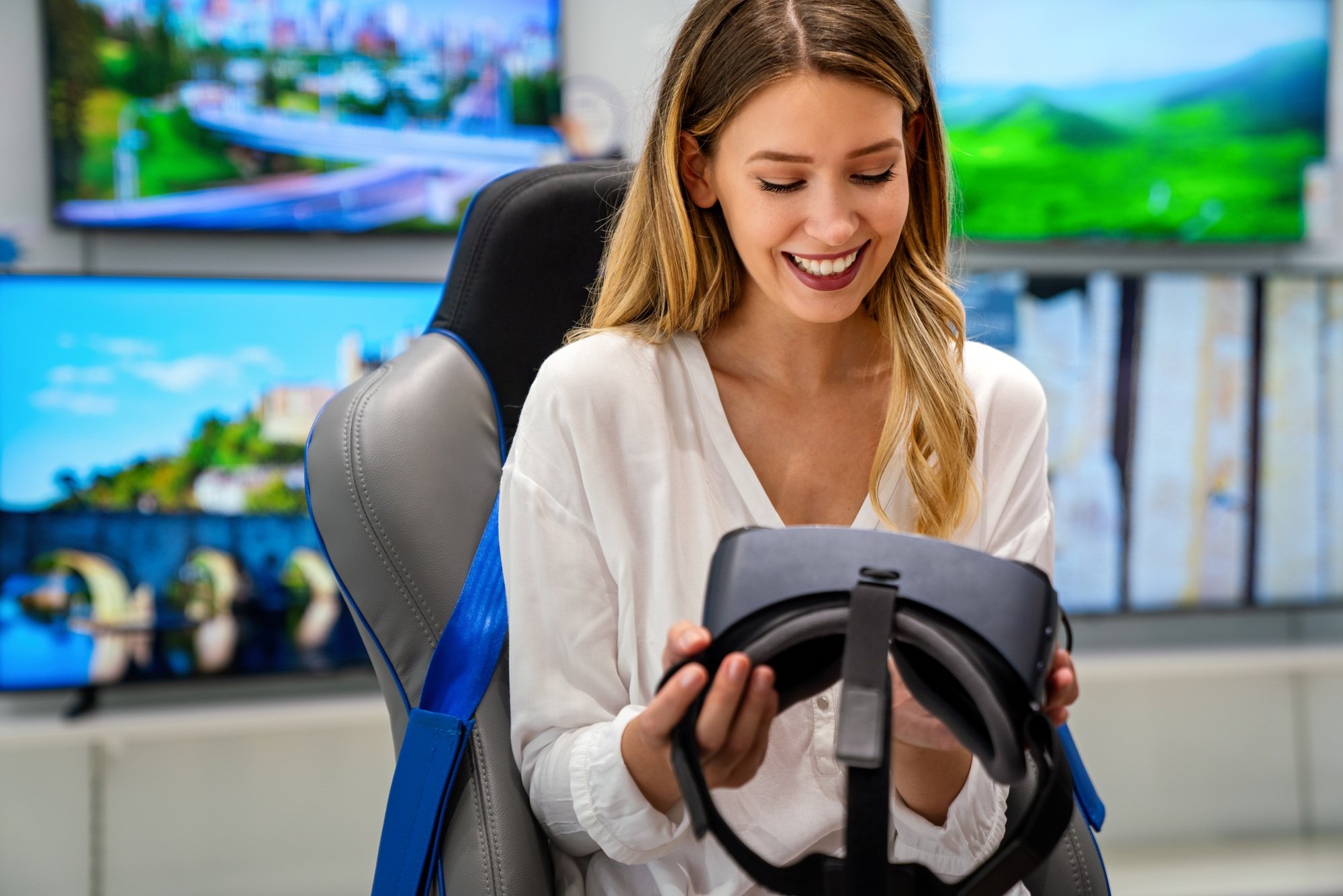 Happy woman using VR goggles and enjoying virtual reality game. Technology simulation people concept