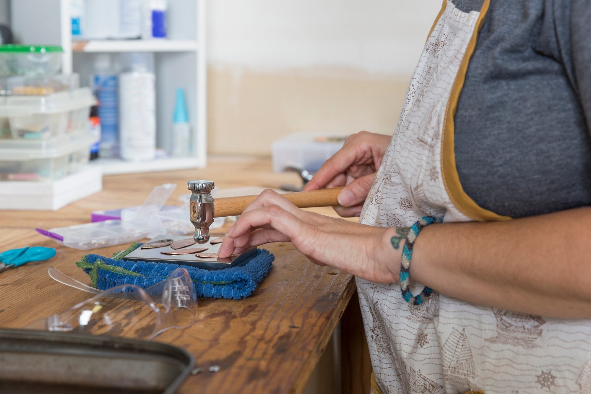 Jewellery maker, making jewellery in workshop, close-up