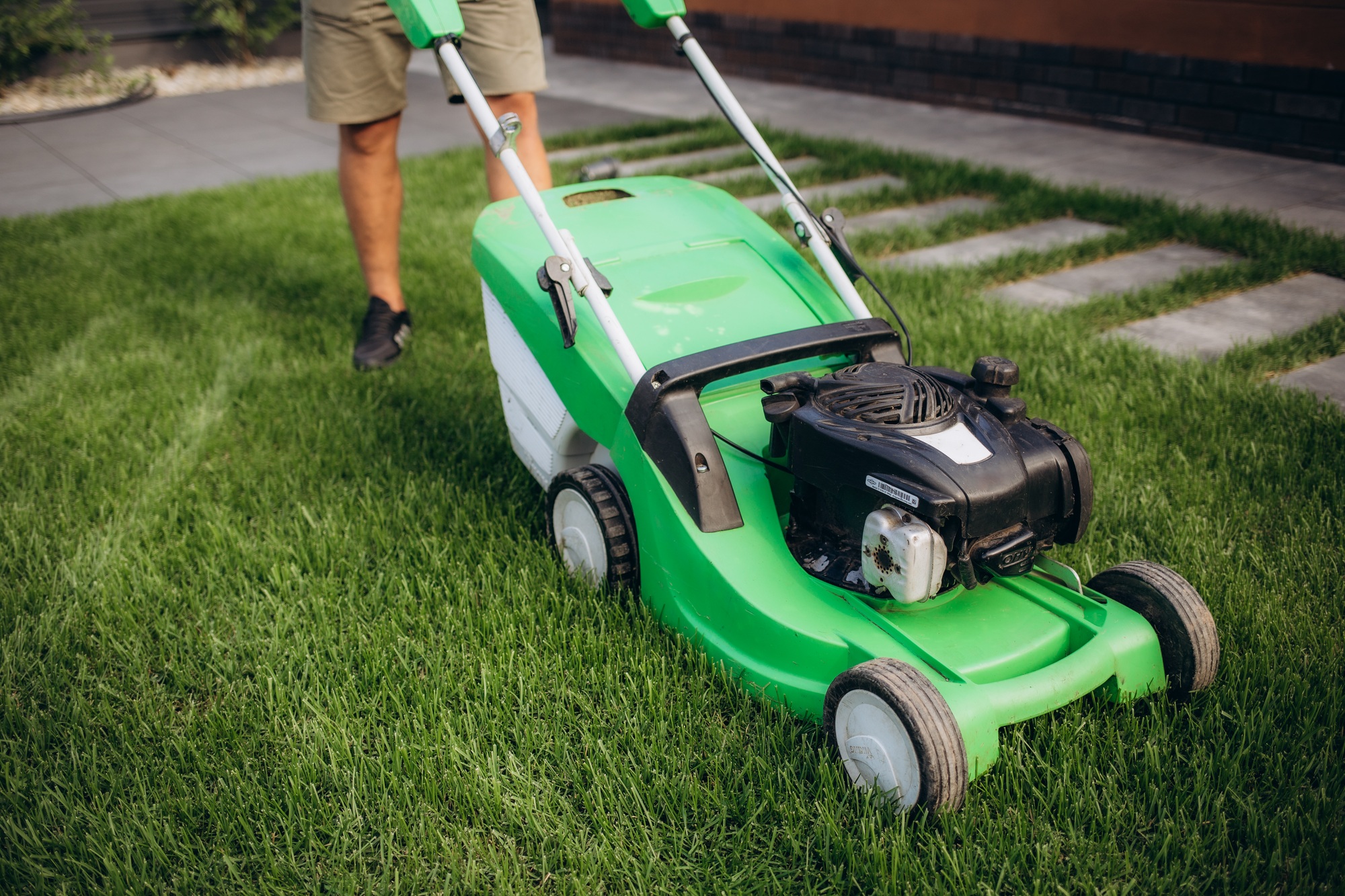 Lawn mover on green grass in modern garden. Machine for cutting lawns.