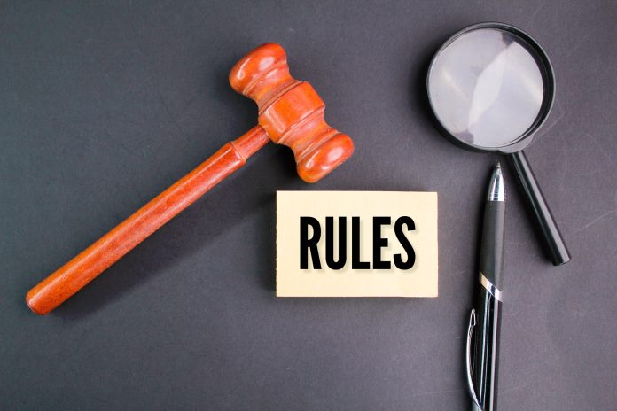 magnifying glass, pen and judge's gavel with the word RULES.