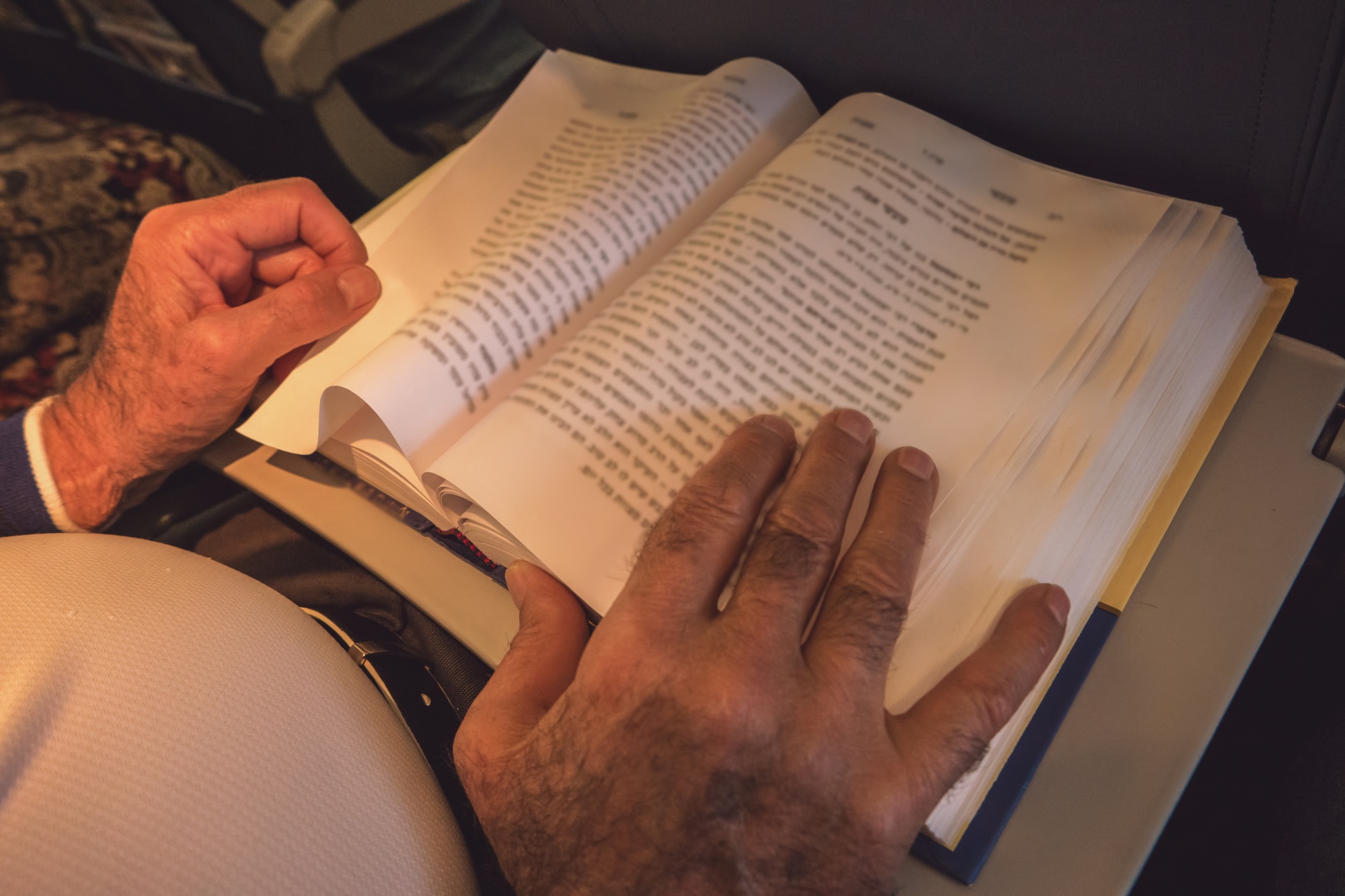 Male hands and opened book.