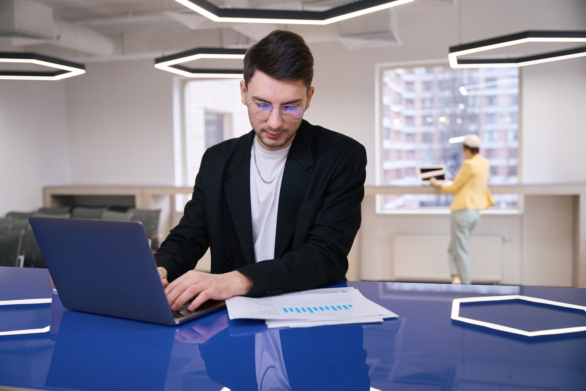 Man inserting data into program on laptop