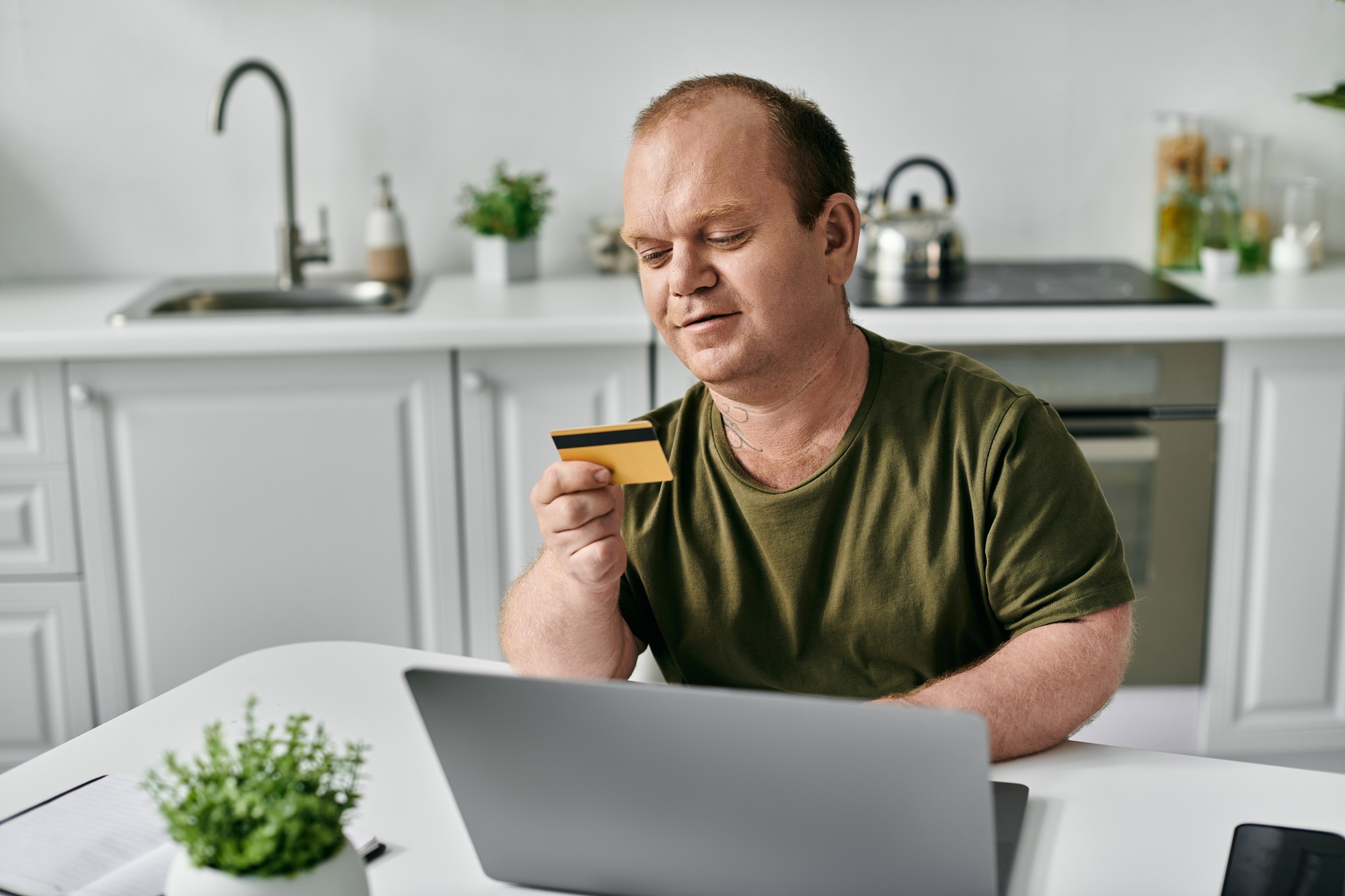 Man Reviewing Credit Card at Home