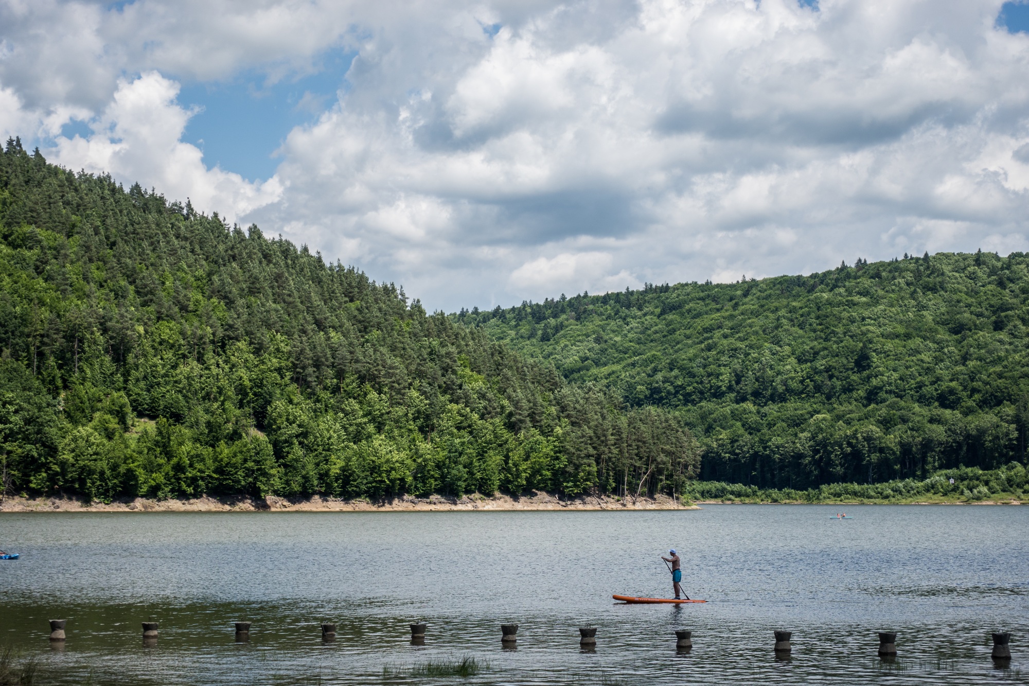 Man with Paddle Board on Lake