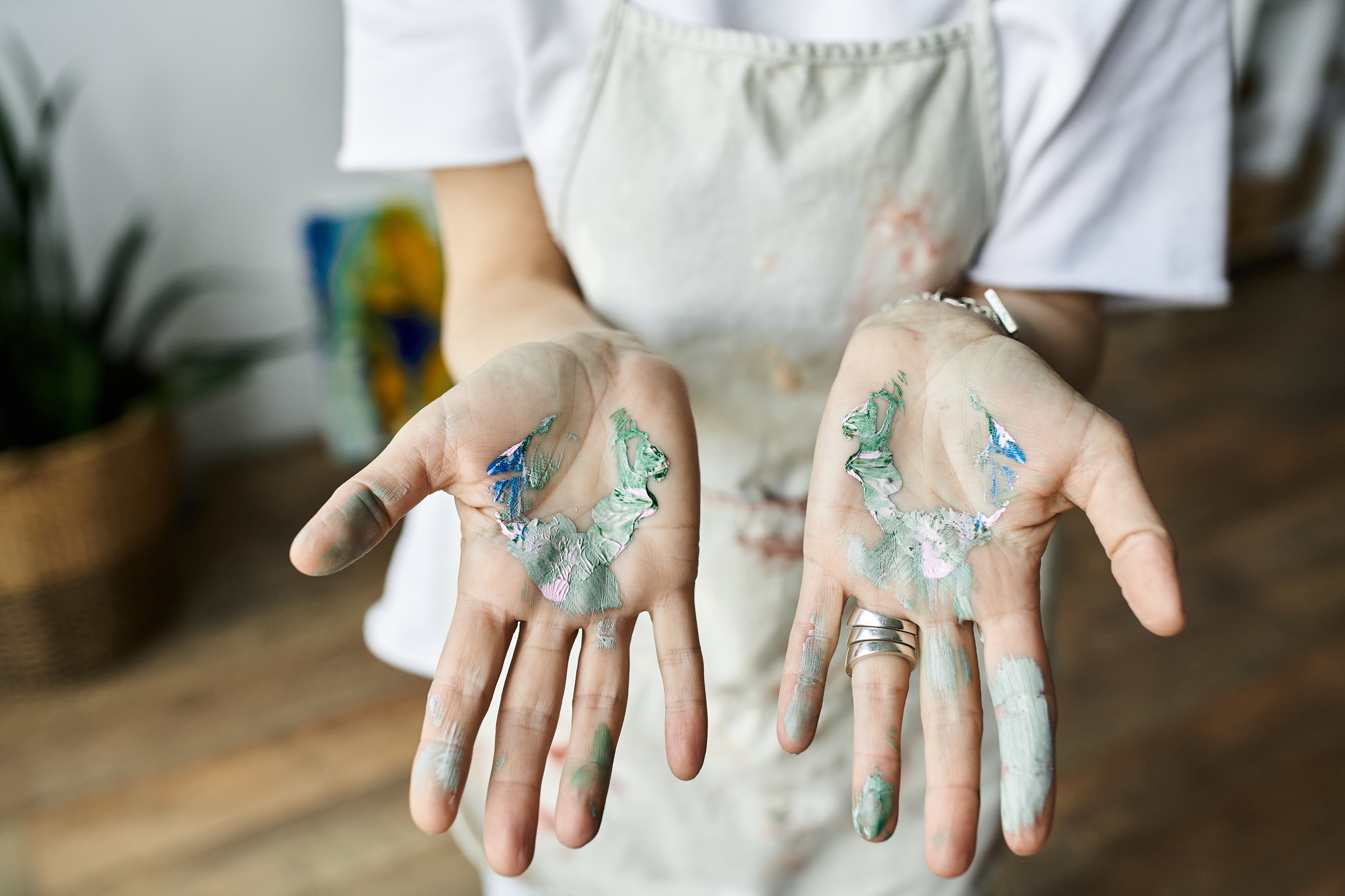 Mature woman joyfully mixing paint in her art studio, creating a vibrant masterpiece