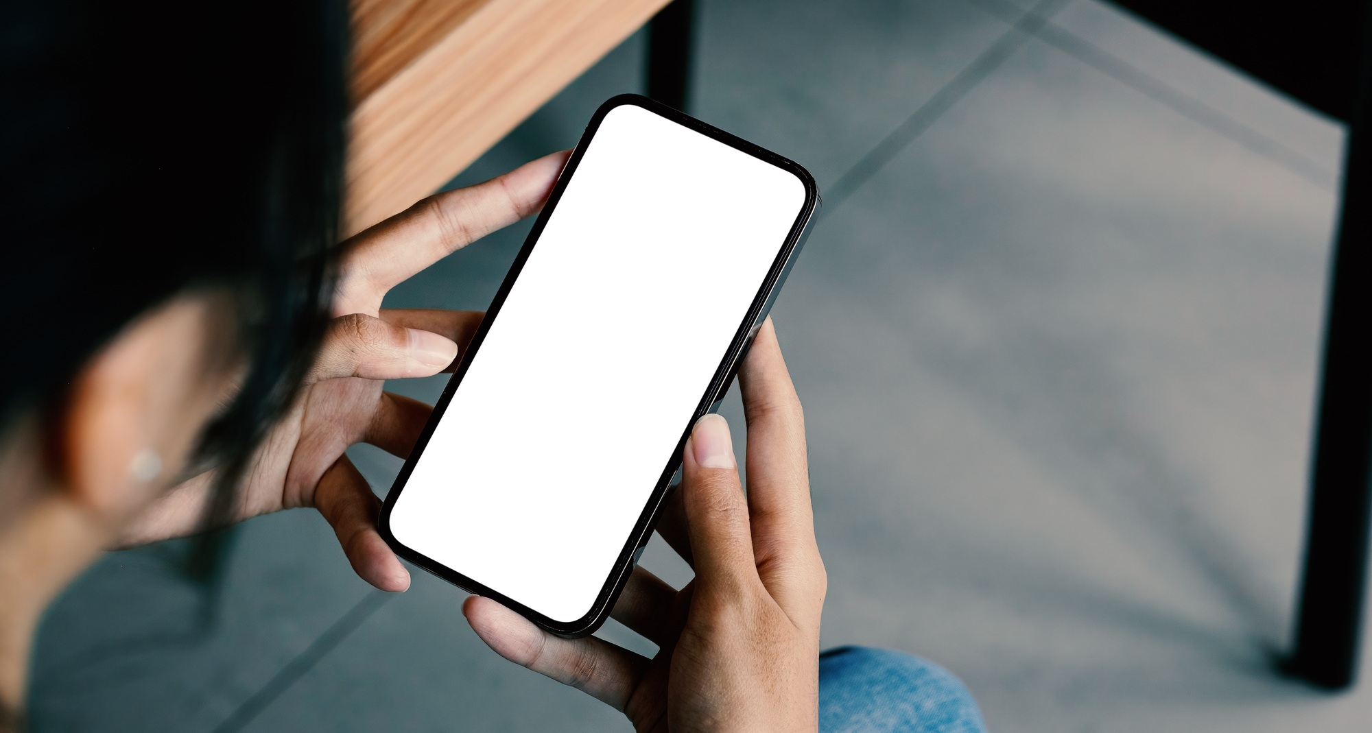 mockup image blank white screen for advertise. woman hand texting using mobile on desk at coffee