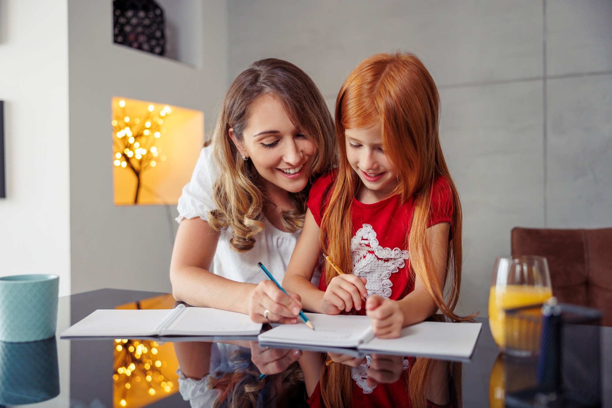 Mother tutoring daughter at home