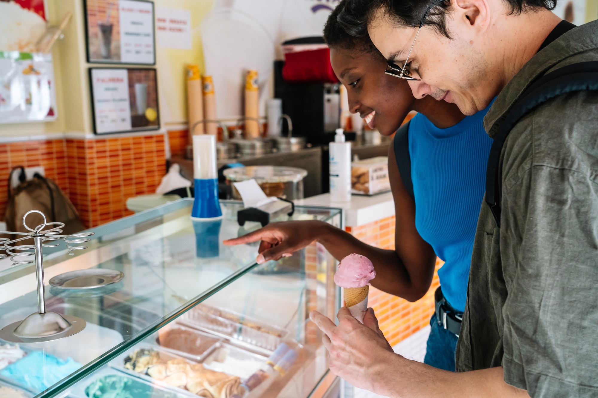 Multi-ethnic couple choosing a ice cream in a shop