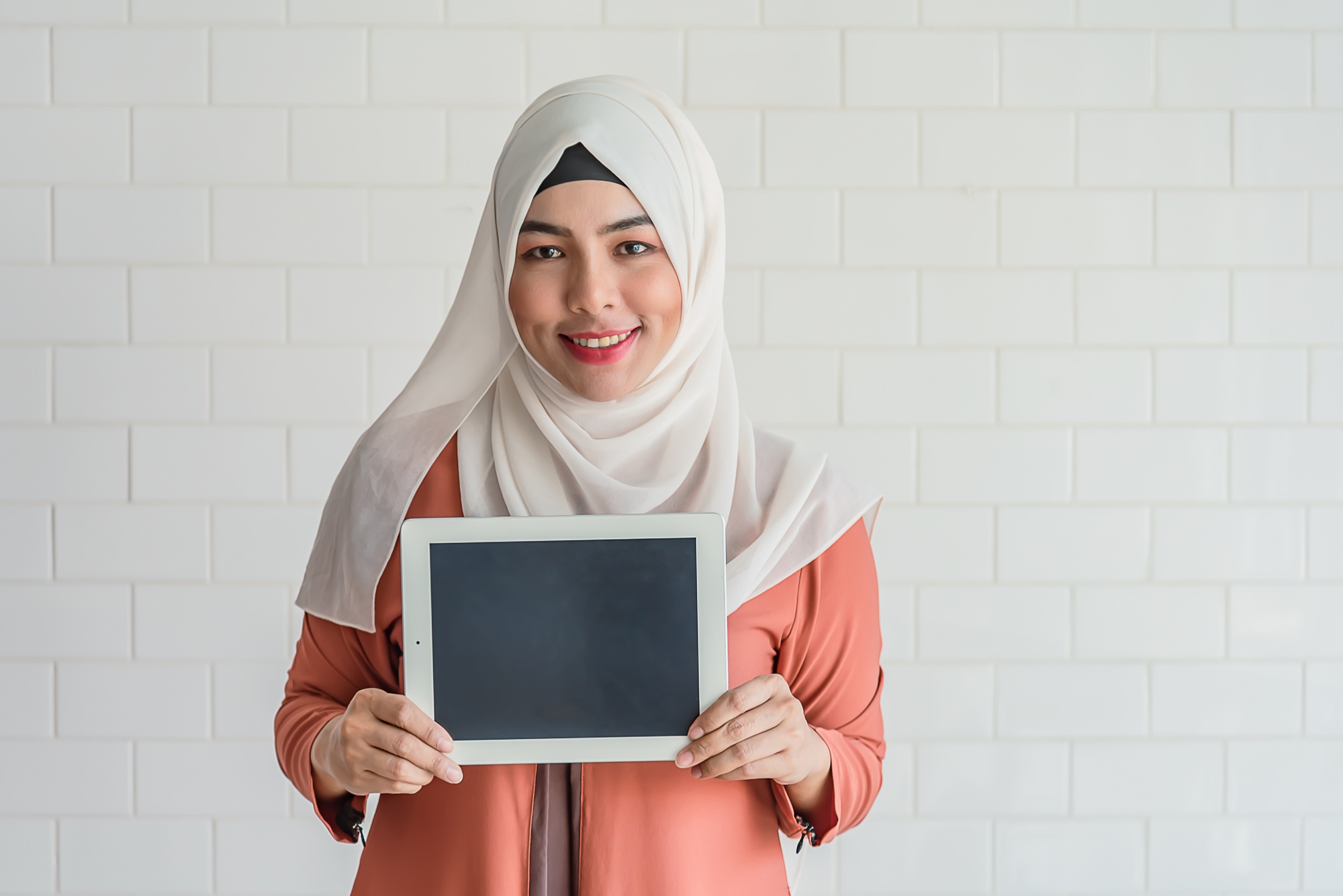 Muslim woman stand hold tablet blank display for ads