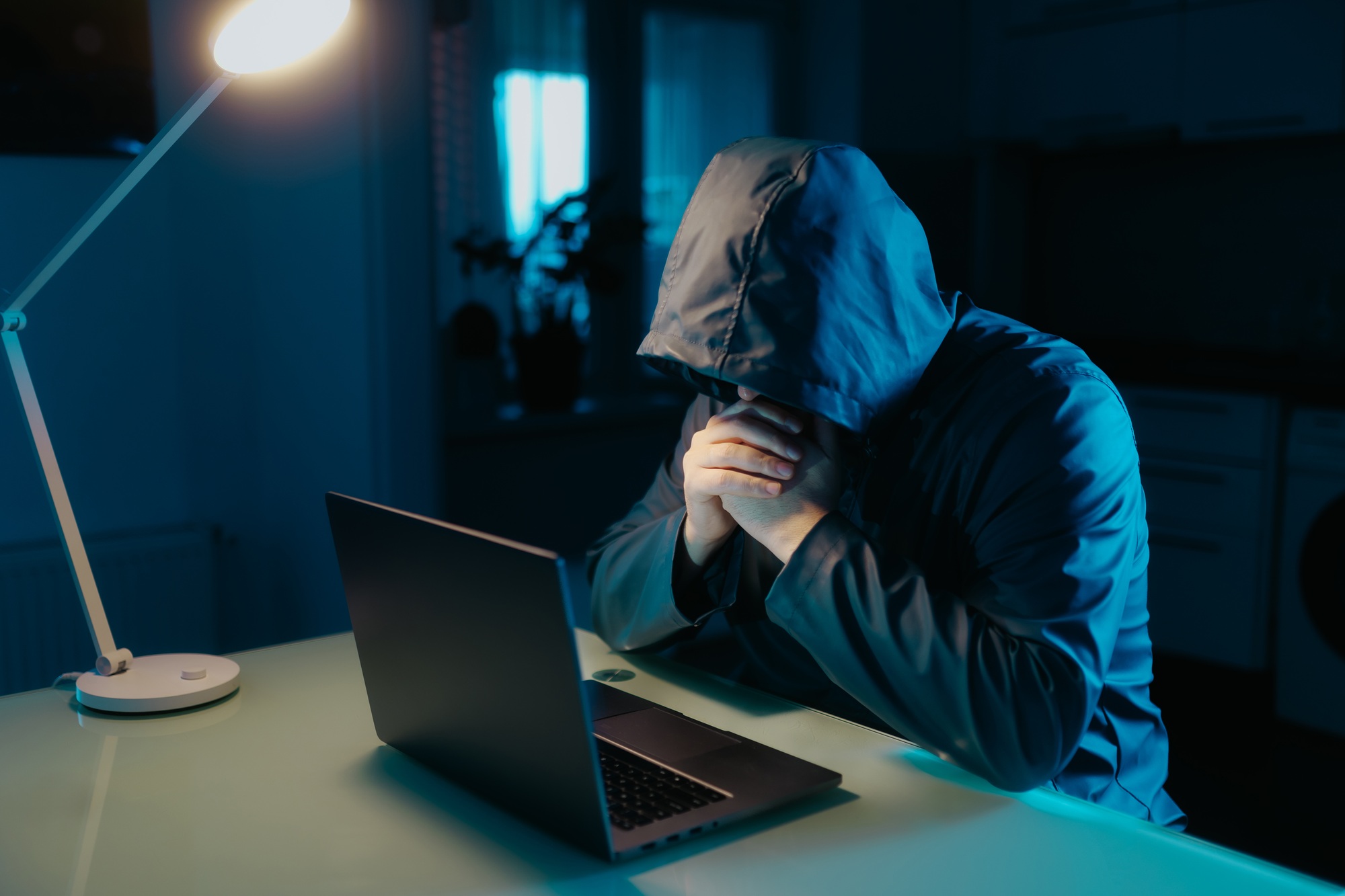 Mysterious Hacker Using Laptop at Home in Dark, Private Space