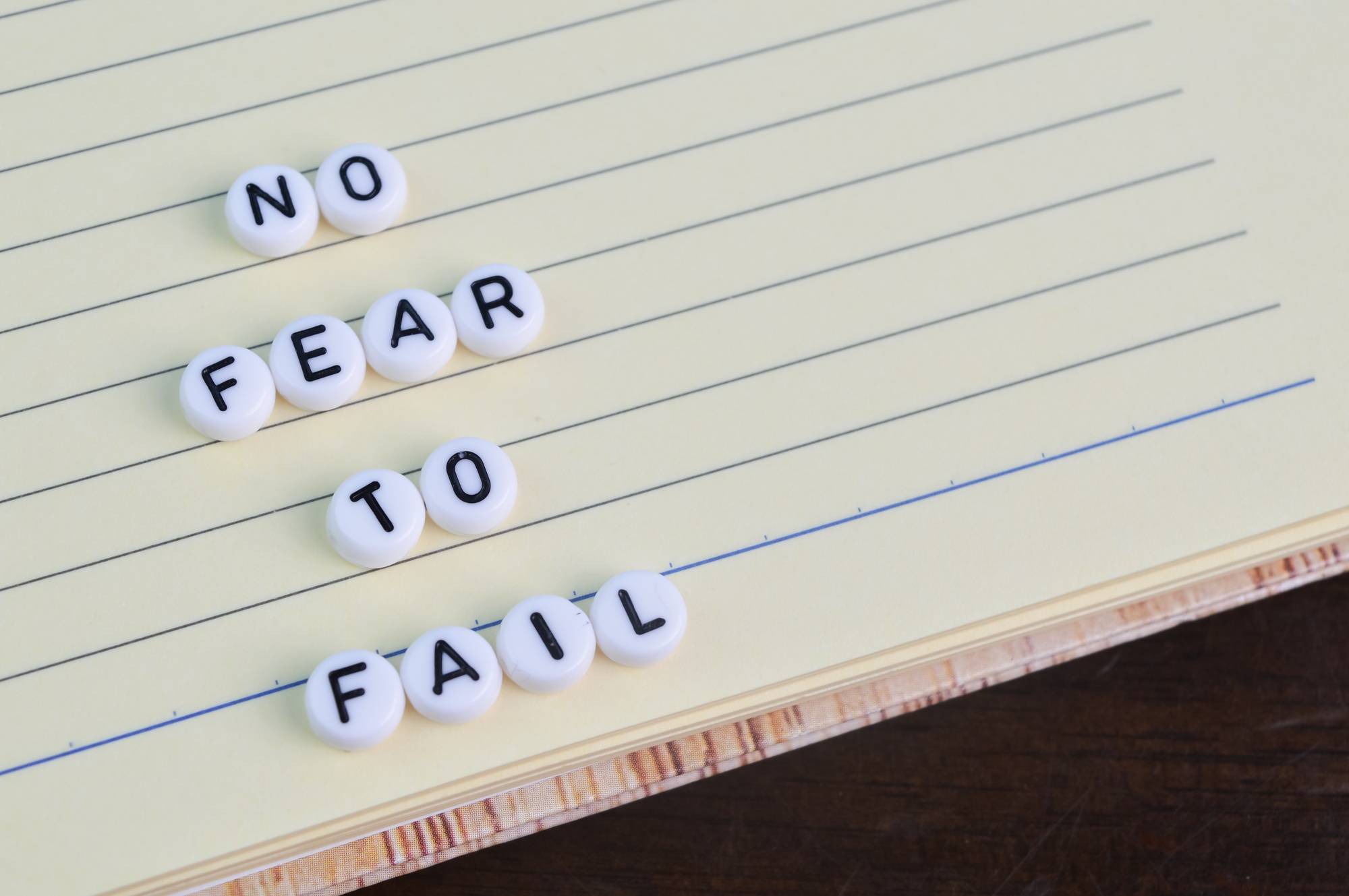 Notebook and alphabet beads with text NO FEAR TO FAIL