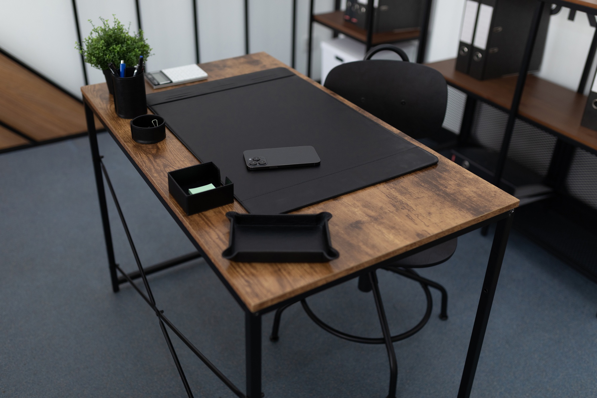 office desk with office supplies in an empty office