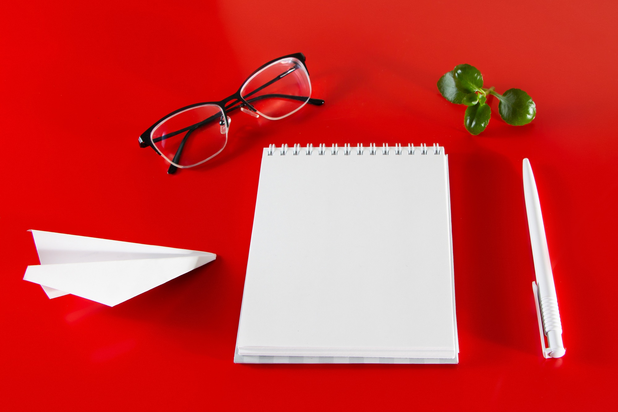 Office supplies on a red background.