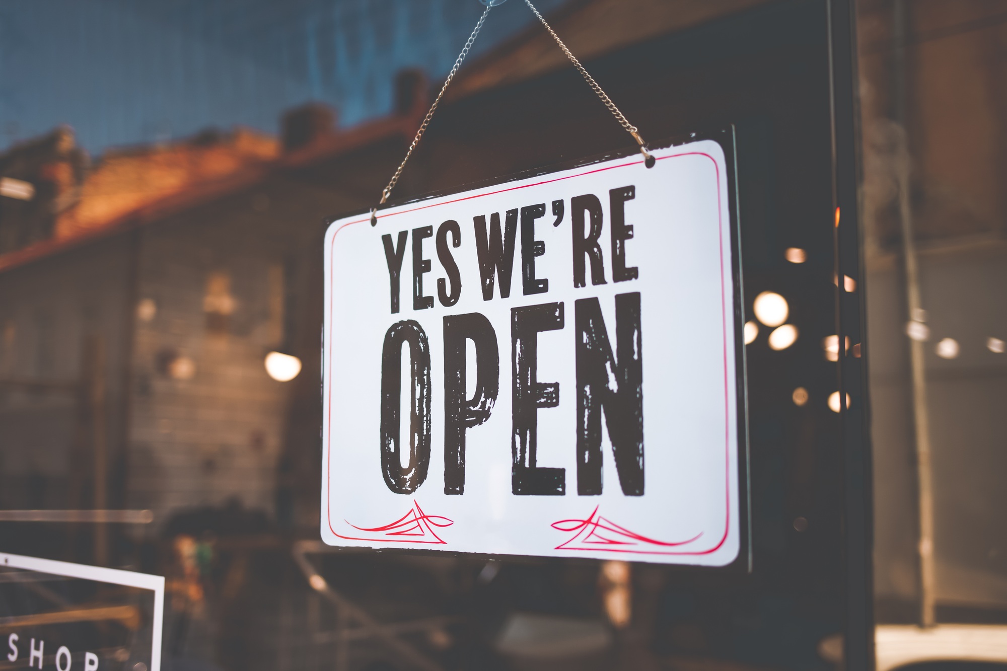 Open sign on the black glass in shop