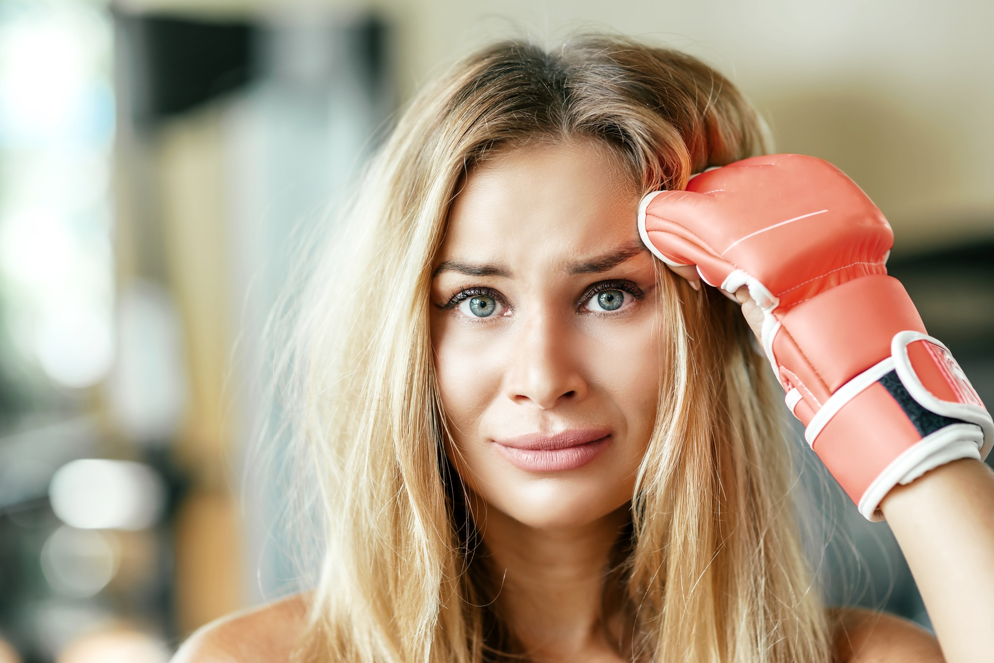 Overcome your fear. Attractive female kickboxer having workout in gym