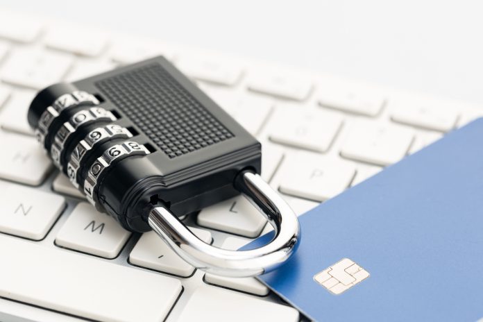 Padlock and credit card on computer keyboard