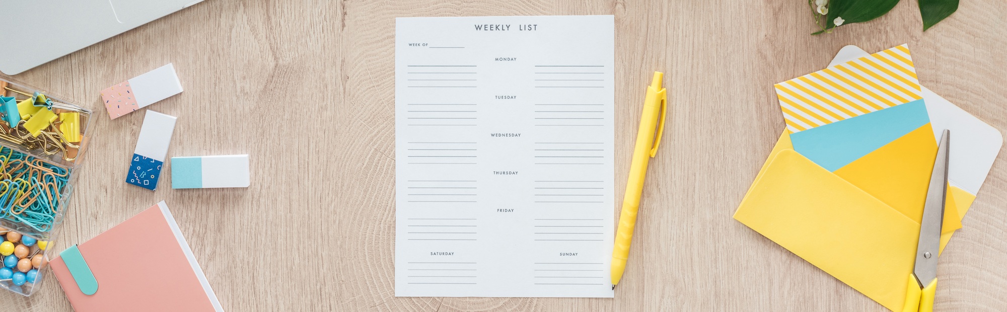 panoramic view of weekly list and stationery on wooden table