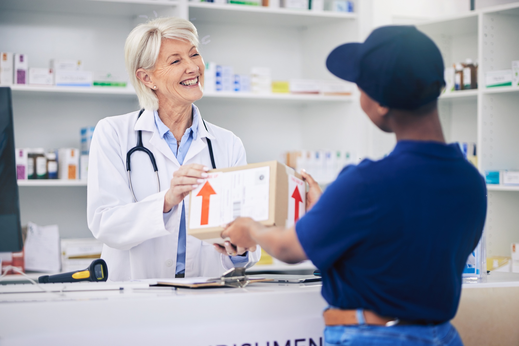 Pharmacist, package and delivery with woman in drug store for medical supplies with courier service
