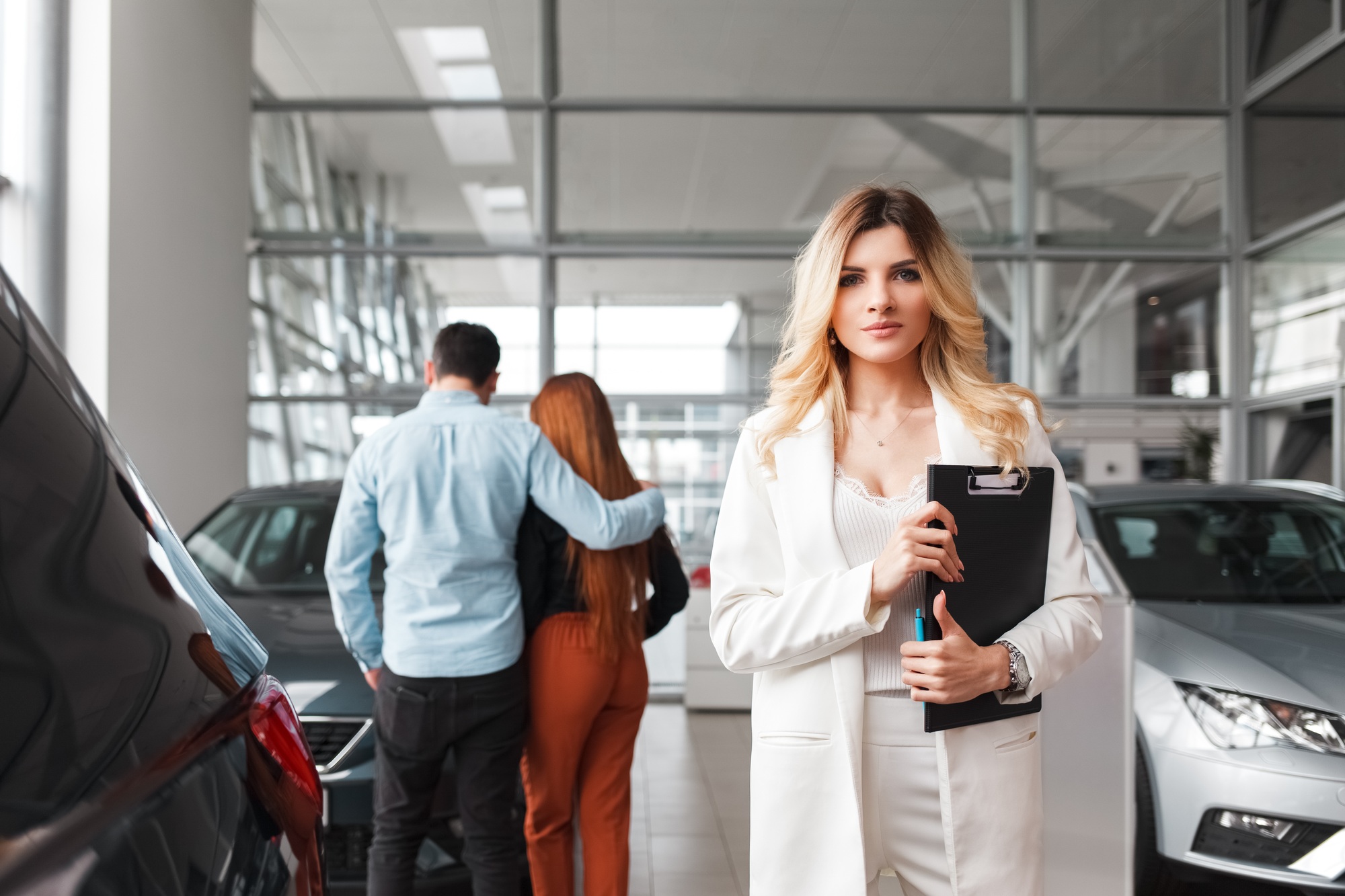 Portrait of a car sales manager woman. Auto dealership representative