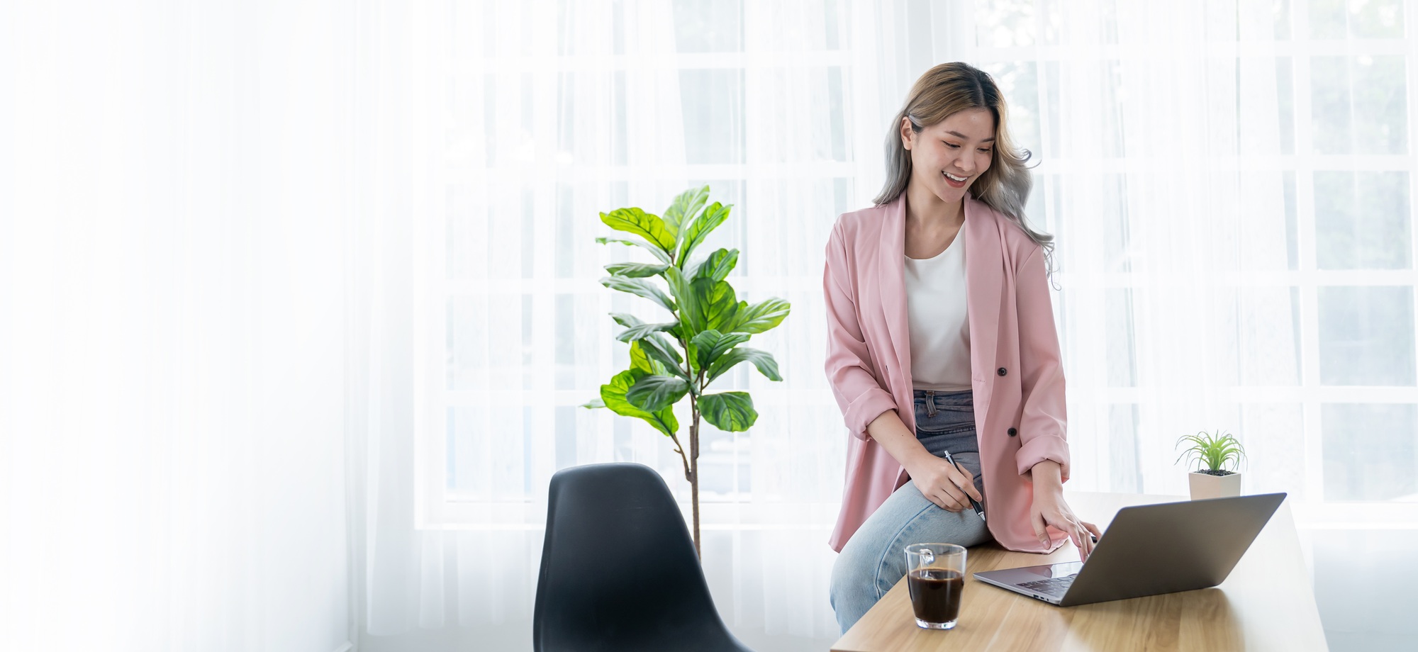 Portrait of beautiful business asian woman pink suit working office desk virtual computer