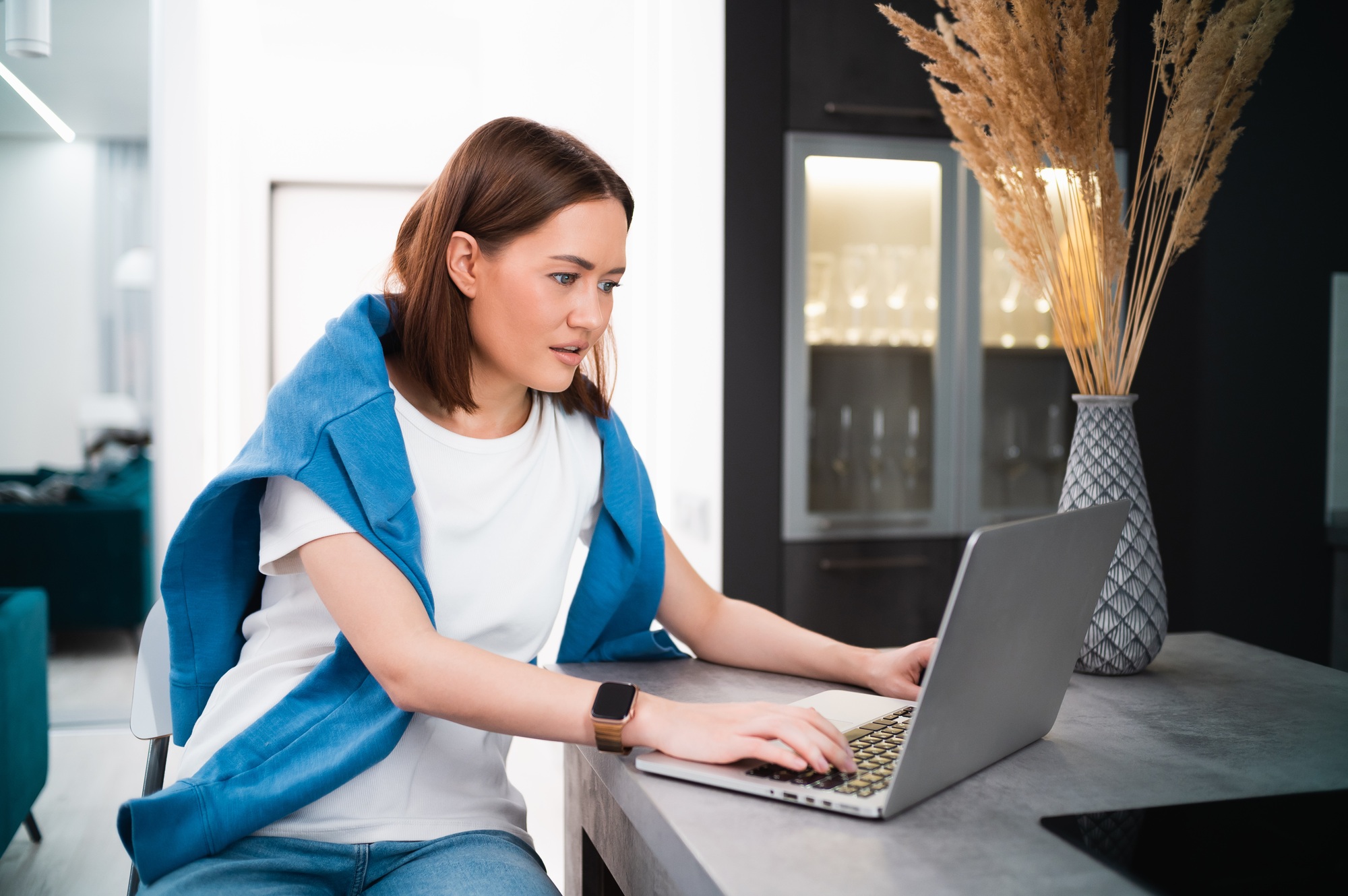 Portrait of gamer girl playing online game on a laptop from home