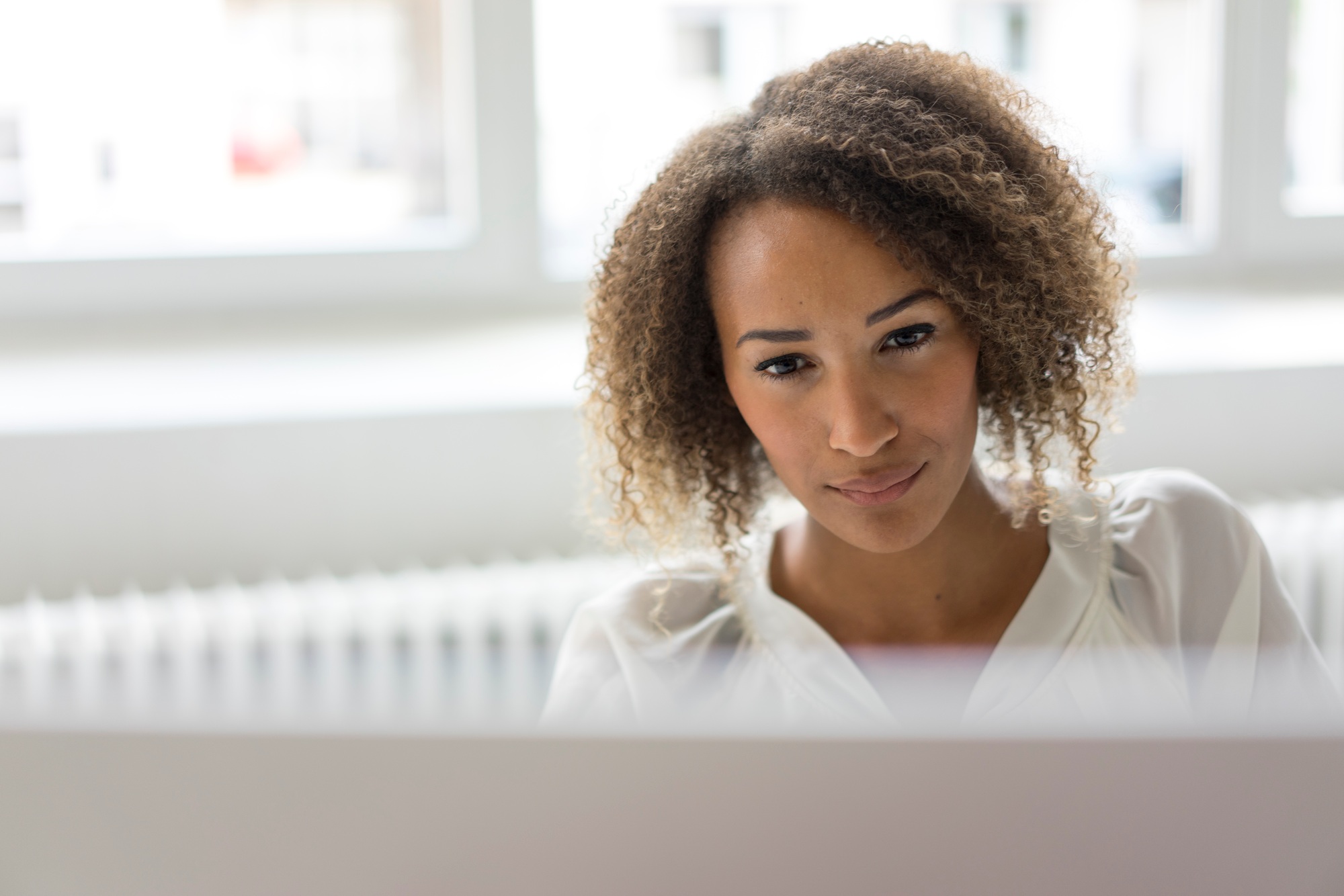 Portrait of smiling young freelancer working at desk