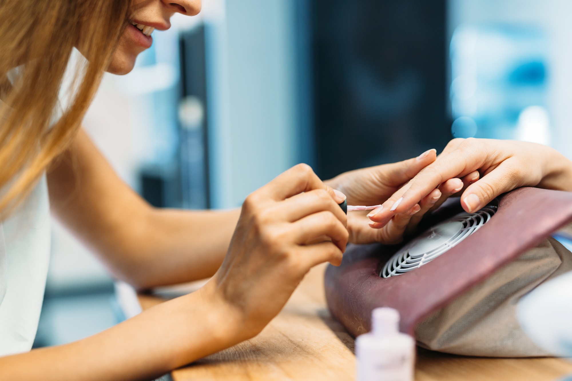 Portrait of woman doing nail polish in beauty salon