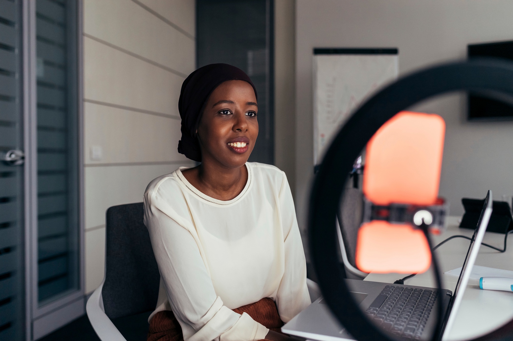 Professional woman recording a podcast or participating in a video call.