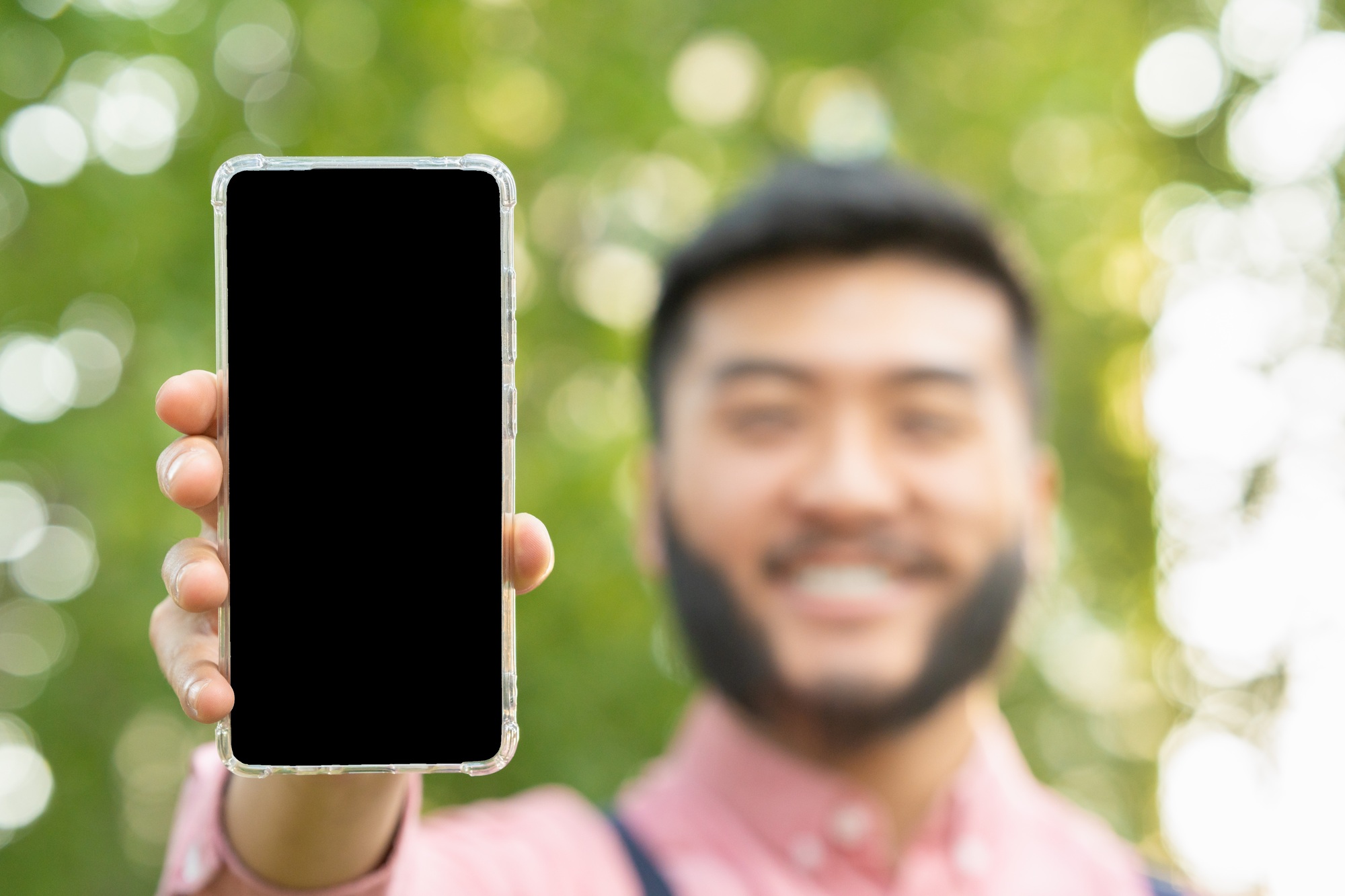 Screen of a mobile phone held by an man